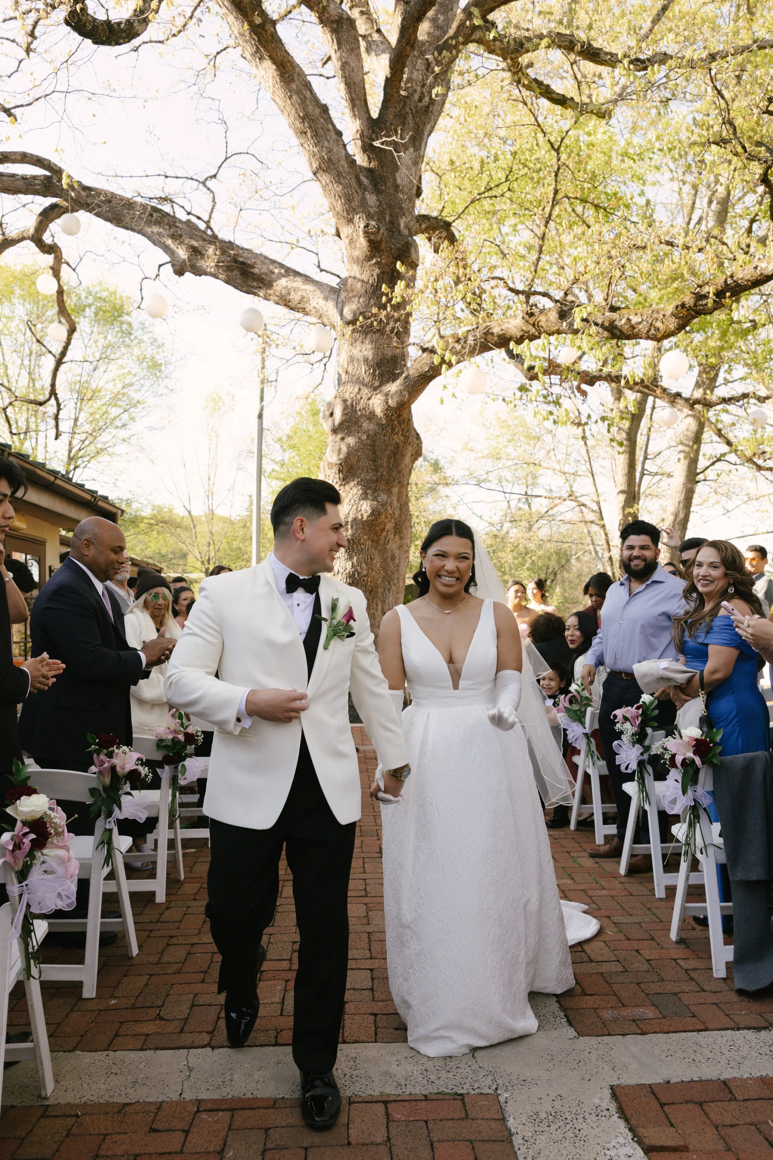 Outdoor wedding ceremony at Hotel DuVillage featuring the bride and groom, wedding party, and meaningful moments captured on both digital and 35mm film. A timeless celebration documented with a candid, documentary approach
