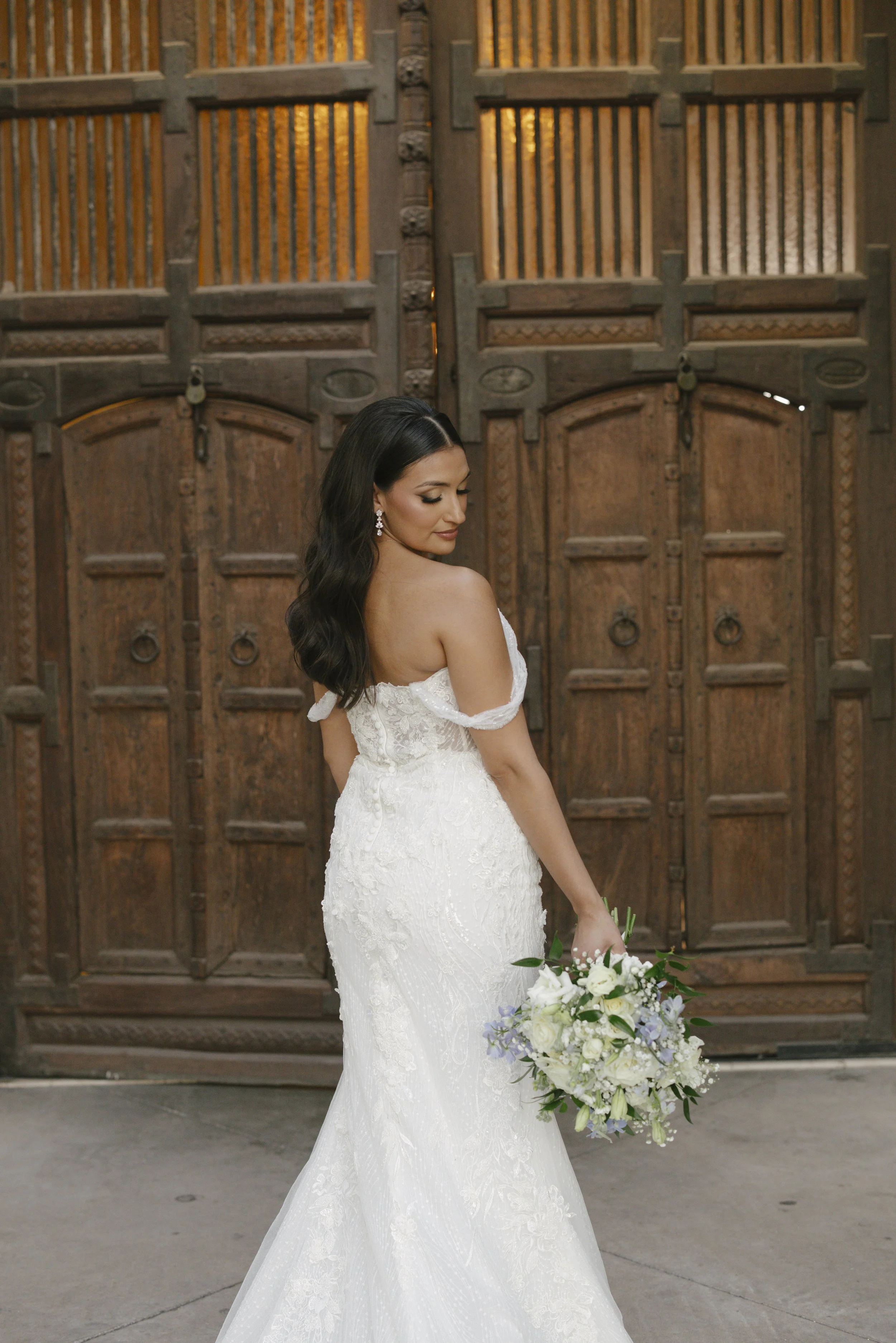 The bride’s solo portraits at Ashley Castle in Chandler, Arizona, were captured through hybrid film and digital photography, highlighting timeless bridal elegance with romantic veil details, graceful movement, and the castle’s stunning courtyard and 