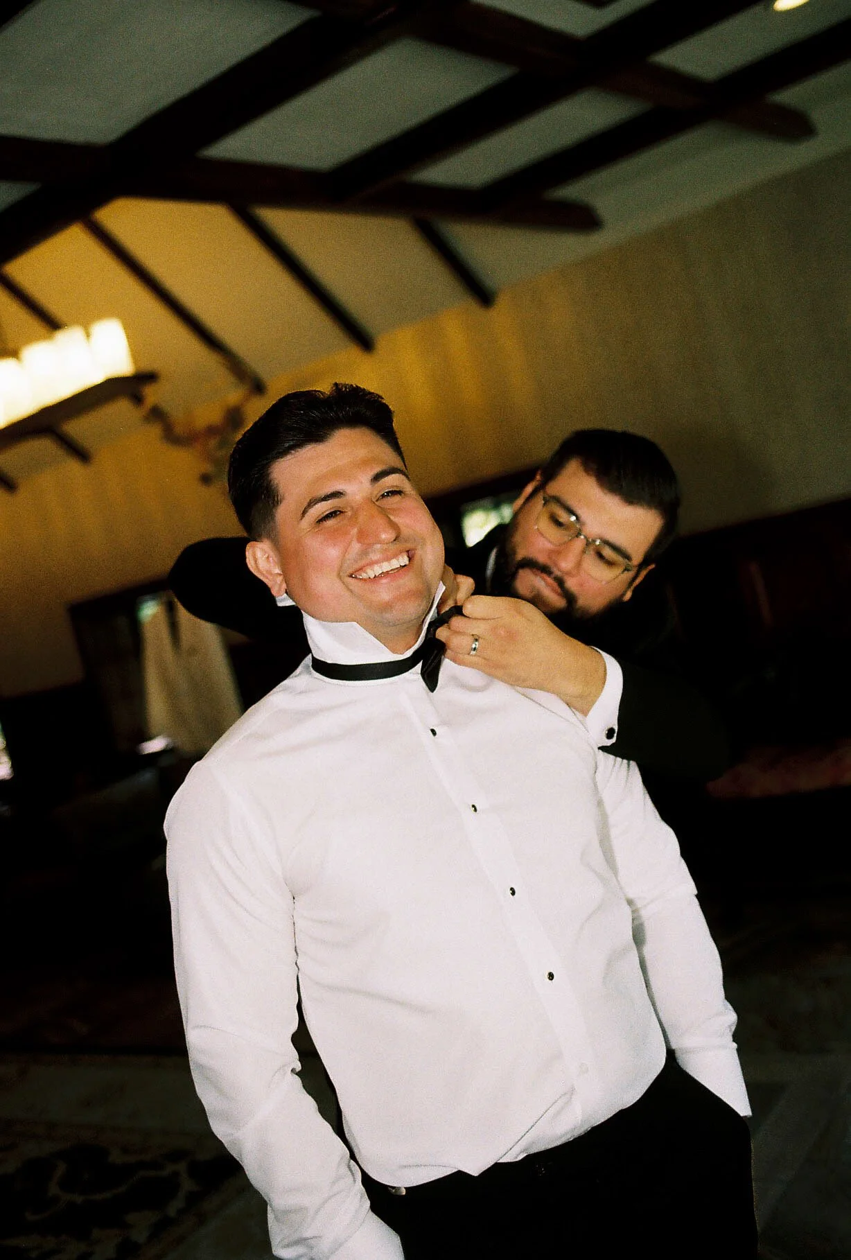 Groom getting ready at Hotel DuVillage before Andy & Elmer's May 2026 wedding. Captured by Raw By Laura using a blend of digital and 35mm film photography, documenting genuine moments with family and friends.
