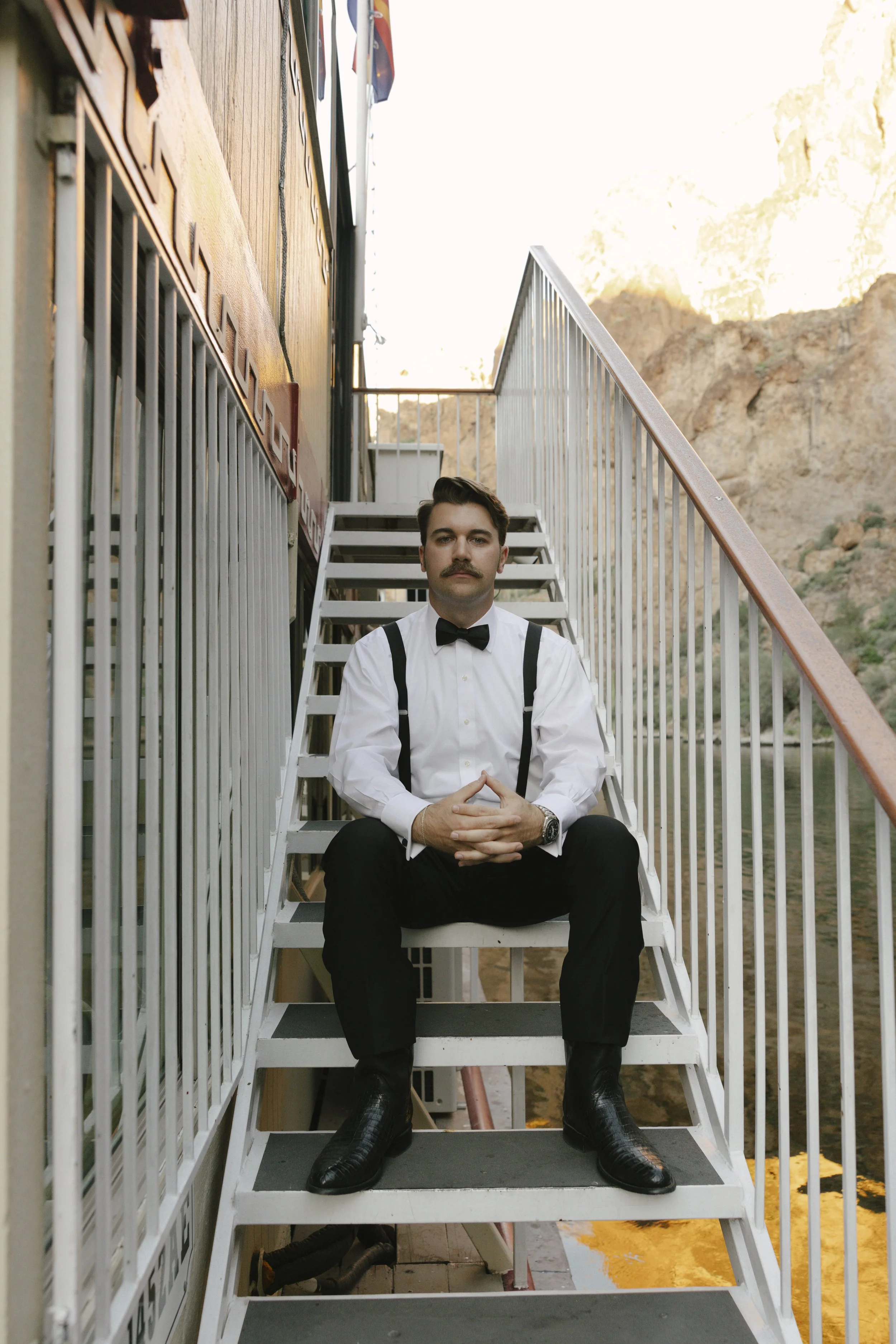 As the sun began to set over Canyon Lake, the couple stepped onto the deck of the Dolly Steamboat for golden hour portraits. With warm Arizona light reflecting off the water and desert mountains surrounding them, these quiet moments captured the beau