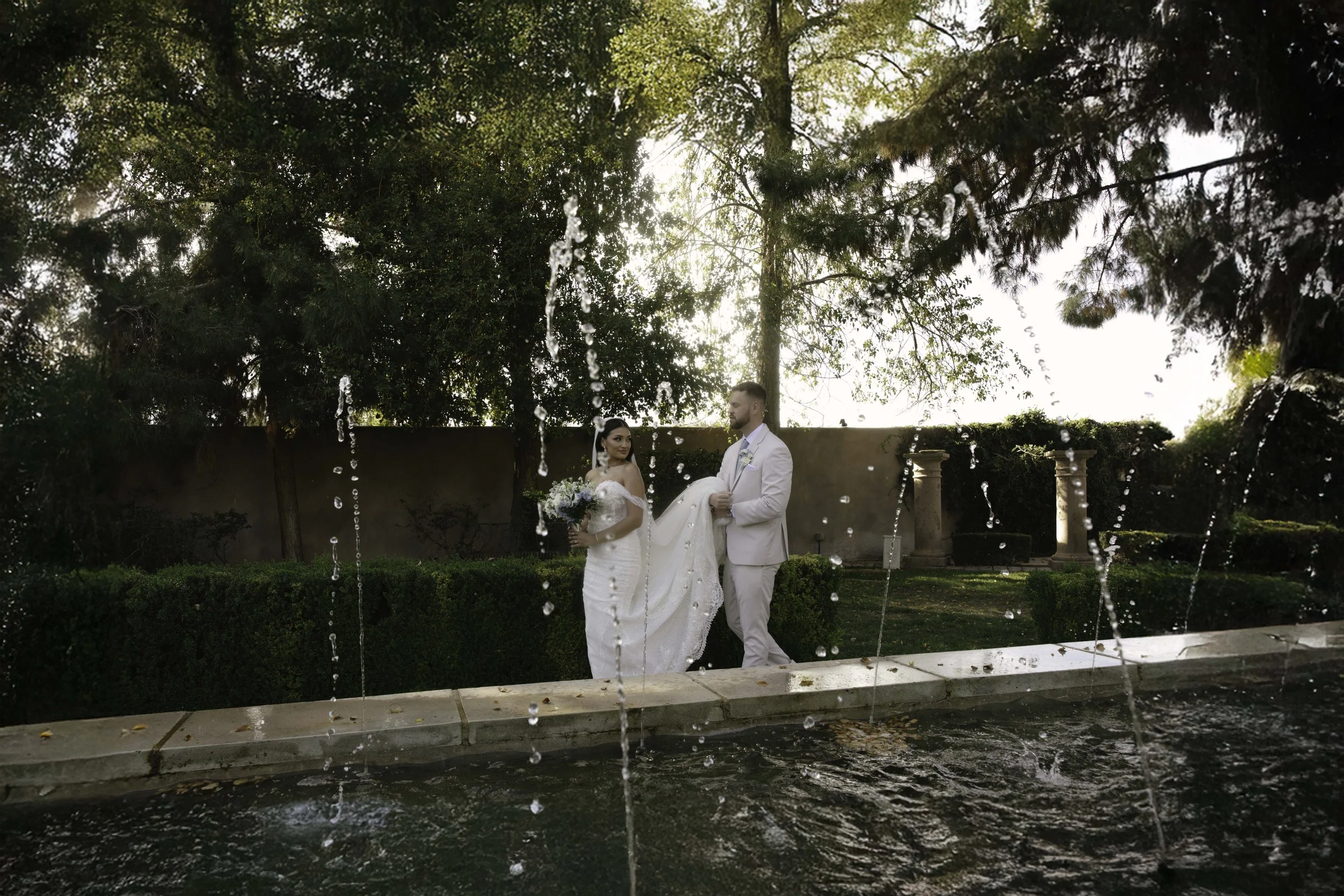Romantic bride and groom portraits at Ashley Castle in Chandler, Arizona, captured through hybrid film and digital photography, showcase intimate newlywed moments filled with emotion, elegant garden backdrops, and timeless wedding-day connection.
