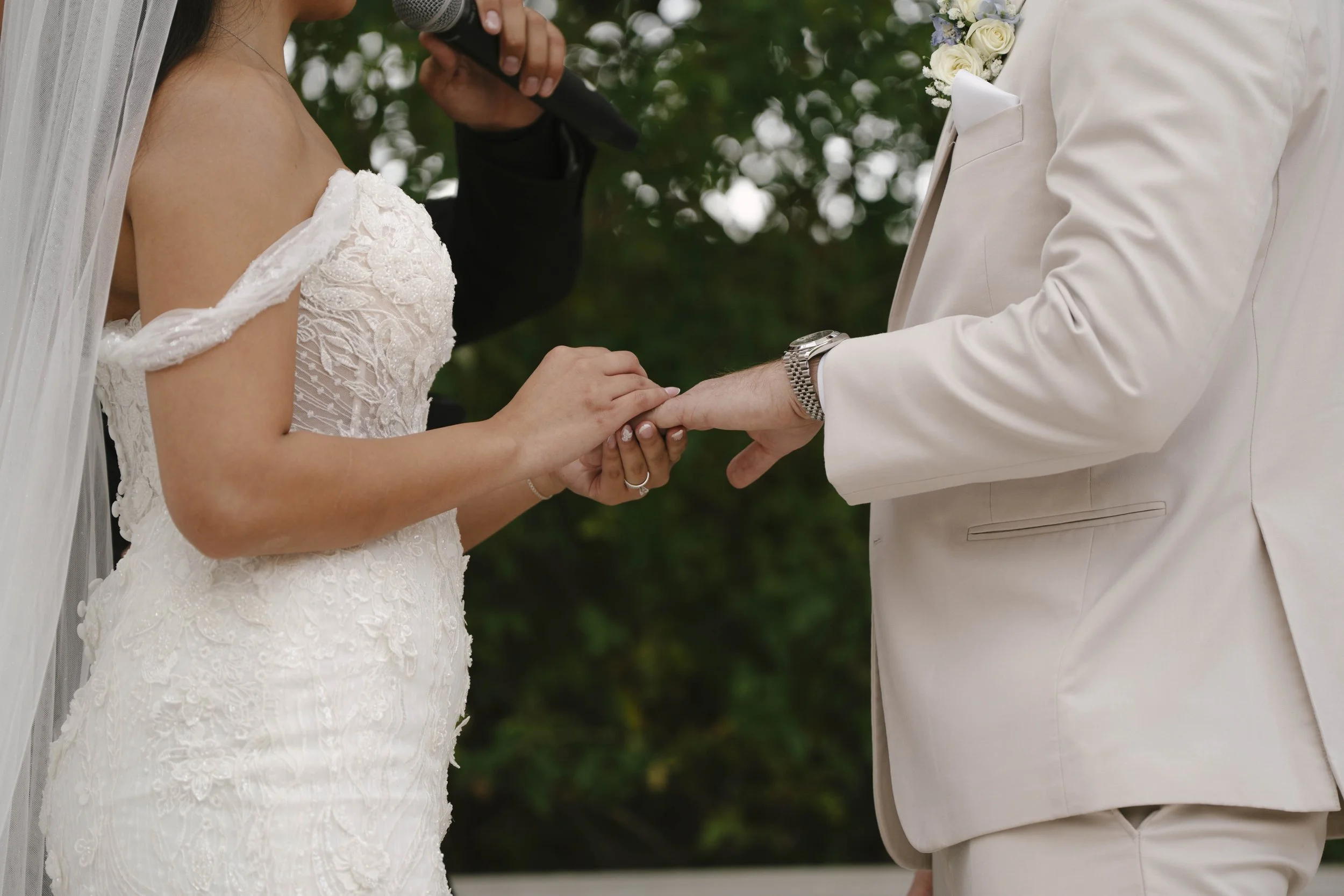 The bride and groom’s ceremony at Ashley Castle in Chandler, Arizona, was beautifully documented through hybrid film and digital photography, capturing their vows, ring exchange, and heartfelt moments beneath a romantic floral altar in the castle’s e