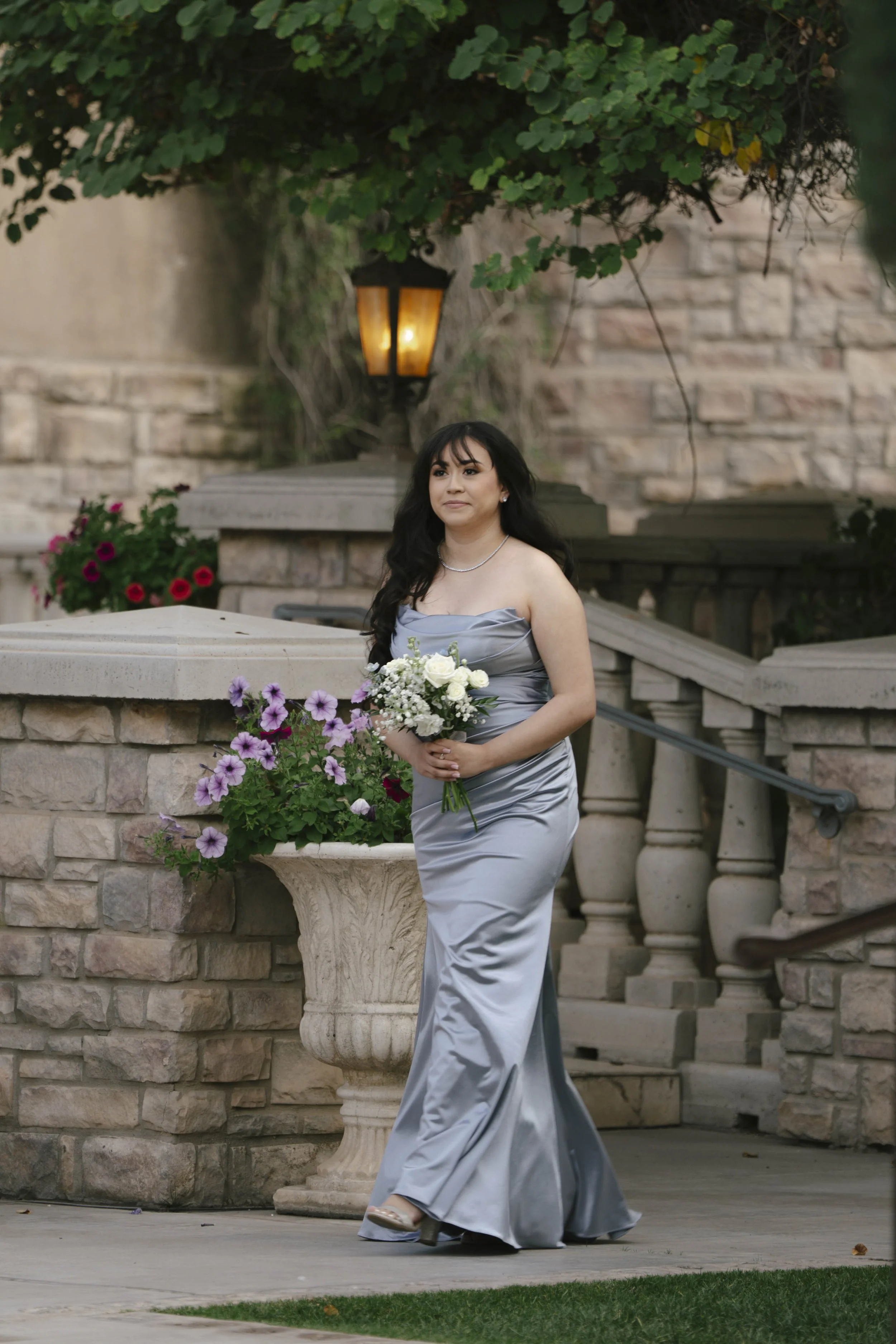 The wedding processional at Ashley Castle in Chandler, Arizona, was captured through hybrid film and digital photography, preserving the graceful entrances of the bridal party as they made their way through the romantic outdoor ceremony space surroun