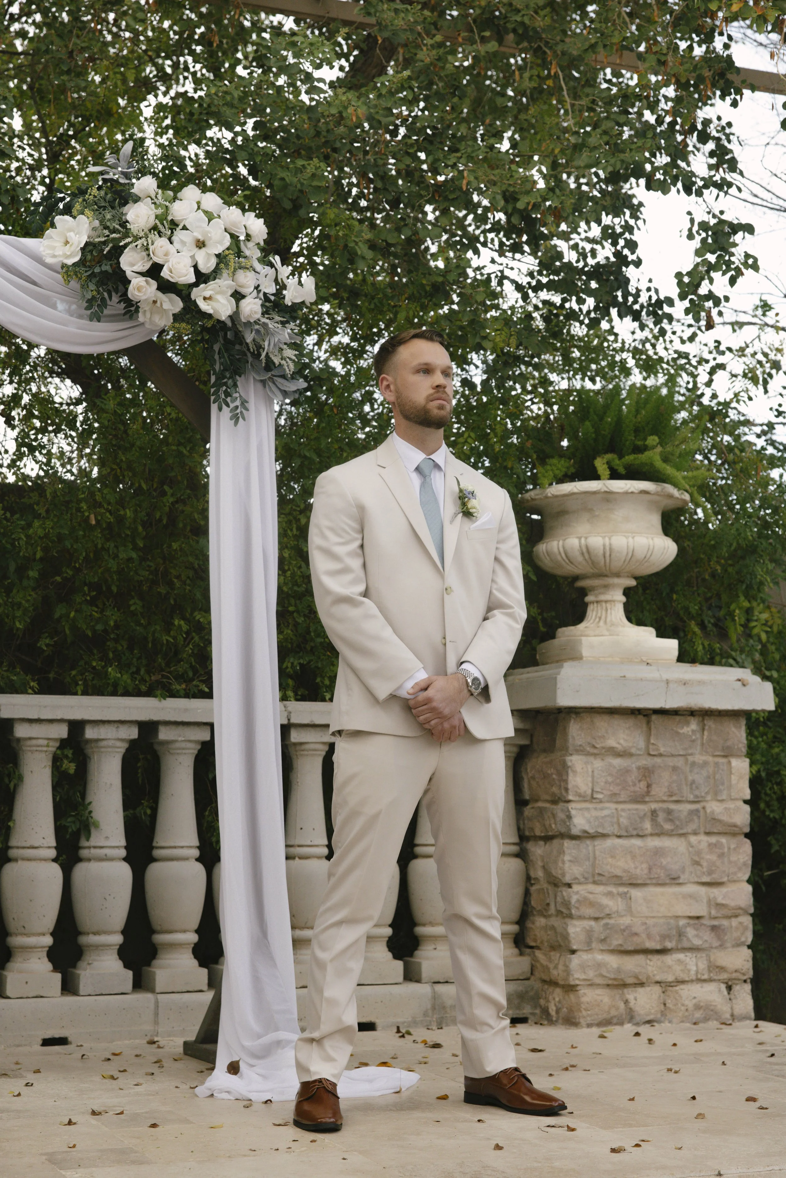 The wedding processional at Ashley Castle in Chandler, Arizona, was captured through hybrid film and digital photography, preserving the graceful entrances of the bridal party as they made their way through the romantic outdoor ceremony space surroun