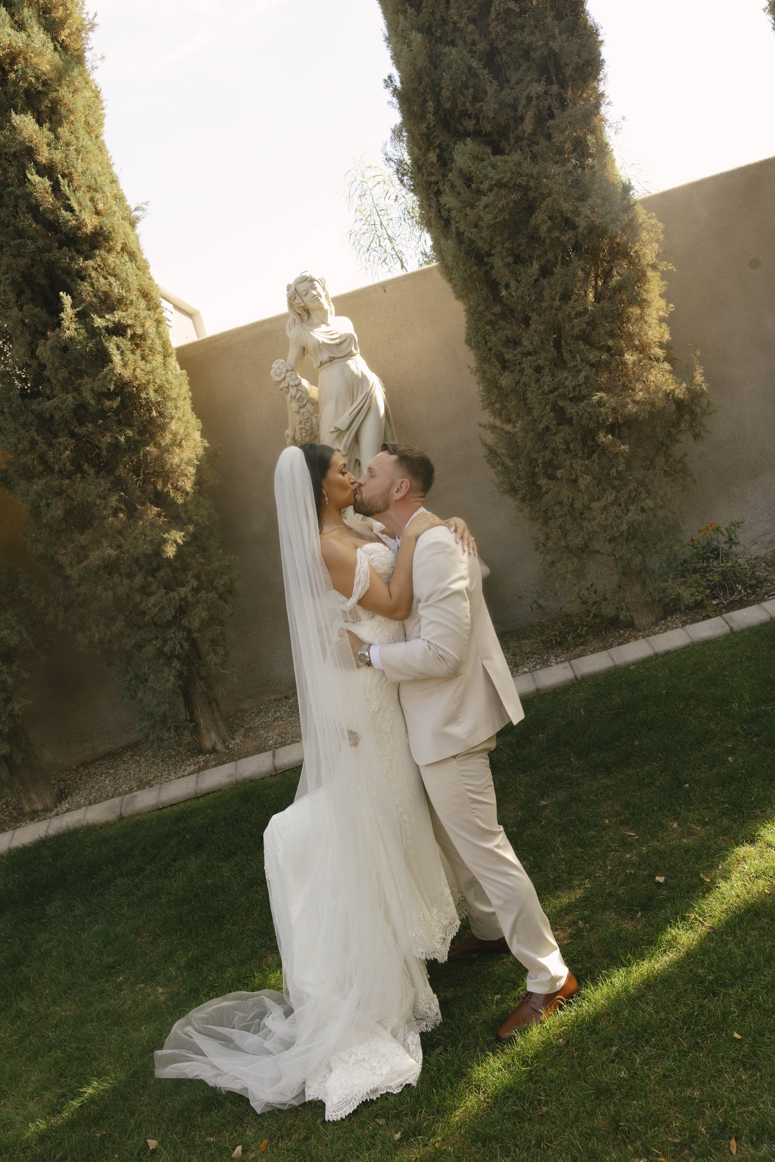 Romantic bride and groom portraits at Ashley Castle in Chandler, Arizona, captured through hybrid film and digital photography, showcase intimate newlywed moments filled with emotion, elegant garden backdrops, and timeless wedding-day connection.