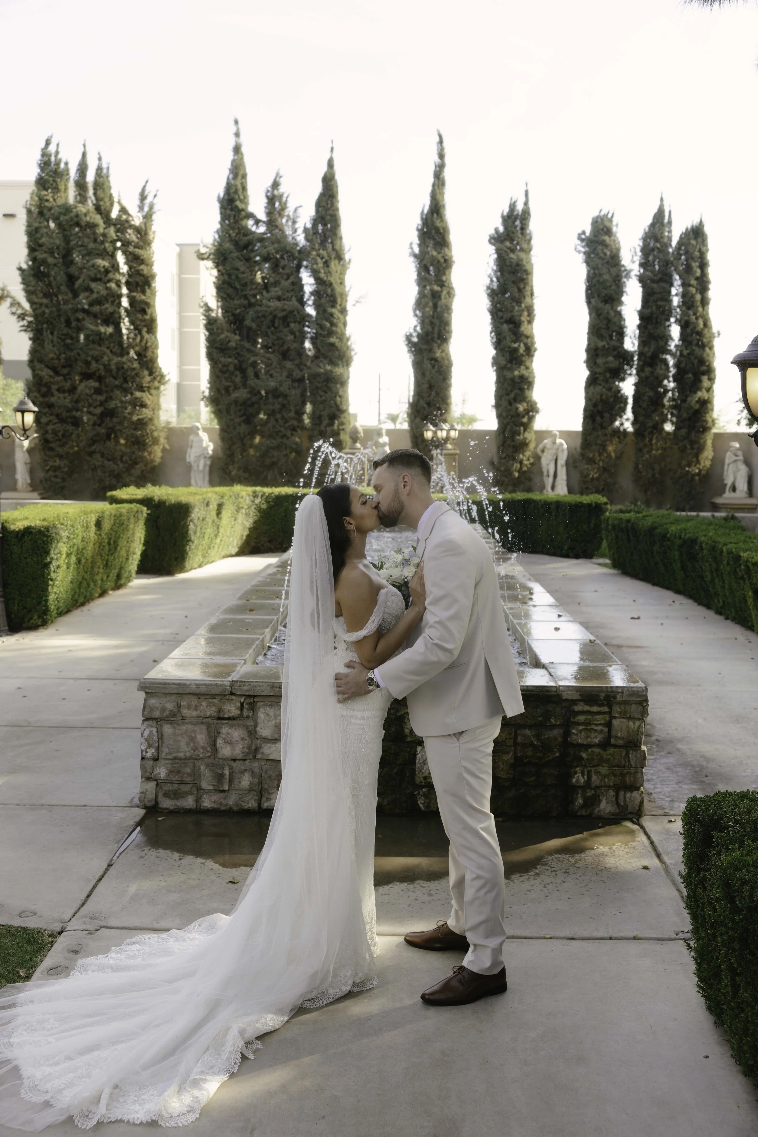 Romantic bride and groom portraits at Ashley Castle in Chandler, Arizona, captured through hybrid film and digital photography, showcase intimate newlywed moments filled with emotion, elegant garden backdrops, and timeless wedding-day connection.