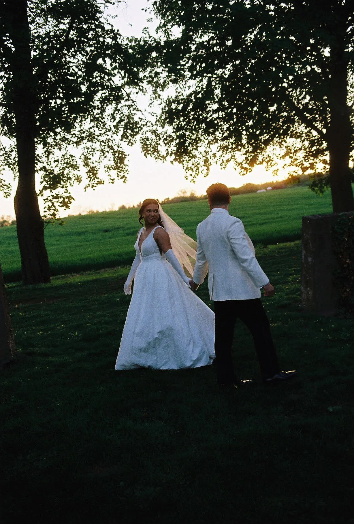 As the sun began to set, the bride and groom stepped away for golden hour portraits around the grounds of Hotel DuVillage. Captured on both digital and 35mm film, these sunset portraits highlight the warmth, romance, and quiet moments shared between 