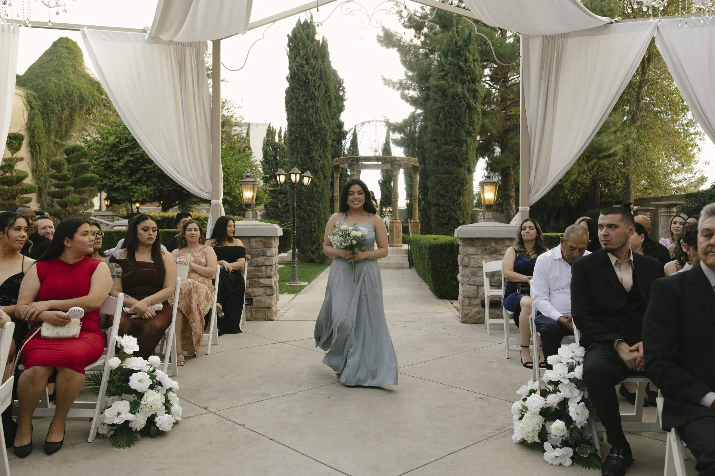 Ceremony details at Ashley Castle in Chandler, Arizona, were thoughtfully captured through hybrid film and digital photography, highlighting elegant signage, romantic seating displays, and the bridesmaid processional as guests gathered for this timel