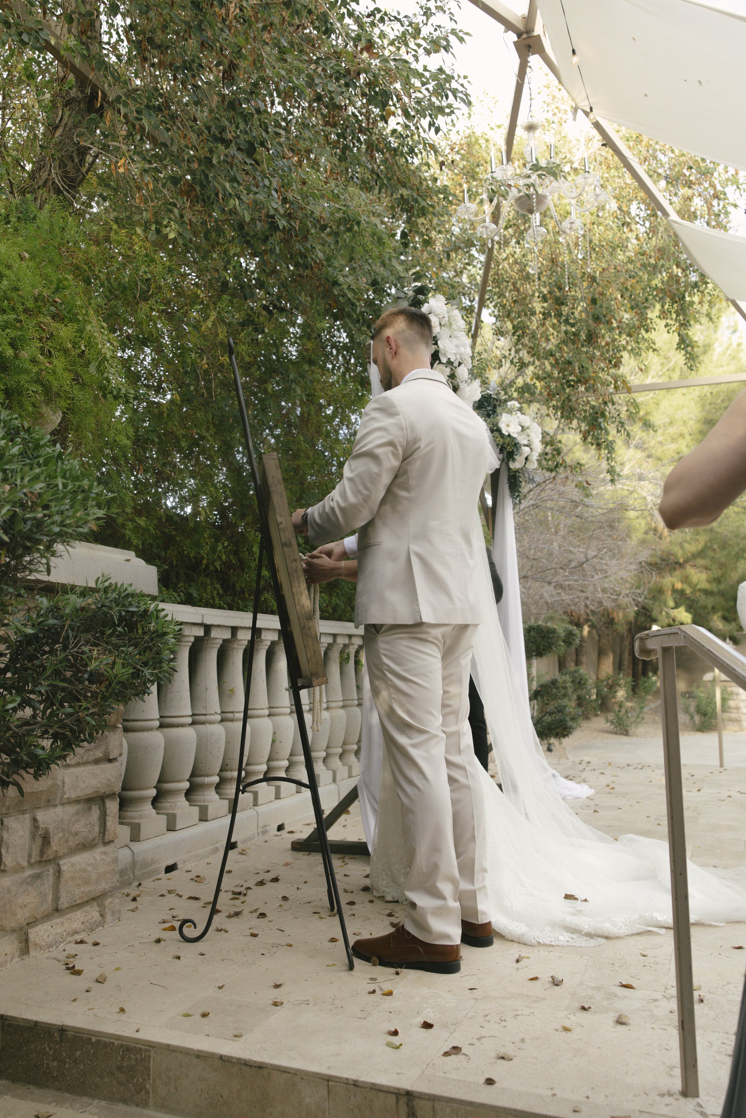 The bride and groom’s ceremony at Ashley Castle in Chandler, Arizona, was beautifully documented through hybrid film and digital photography, capturing their vows, ring exchange, and heartfelt moments beneath a romantic floral altar in the castle’s e