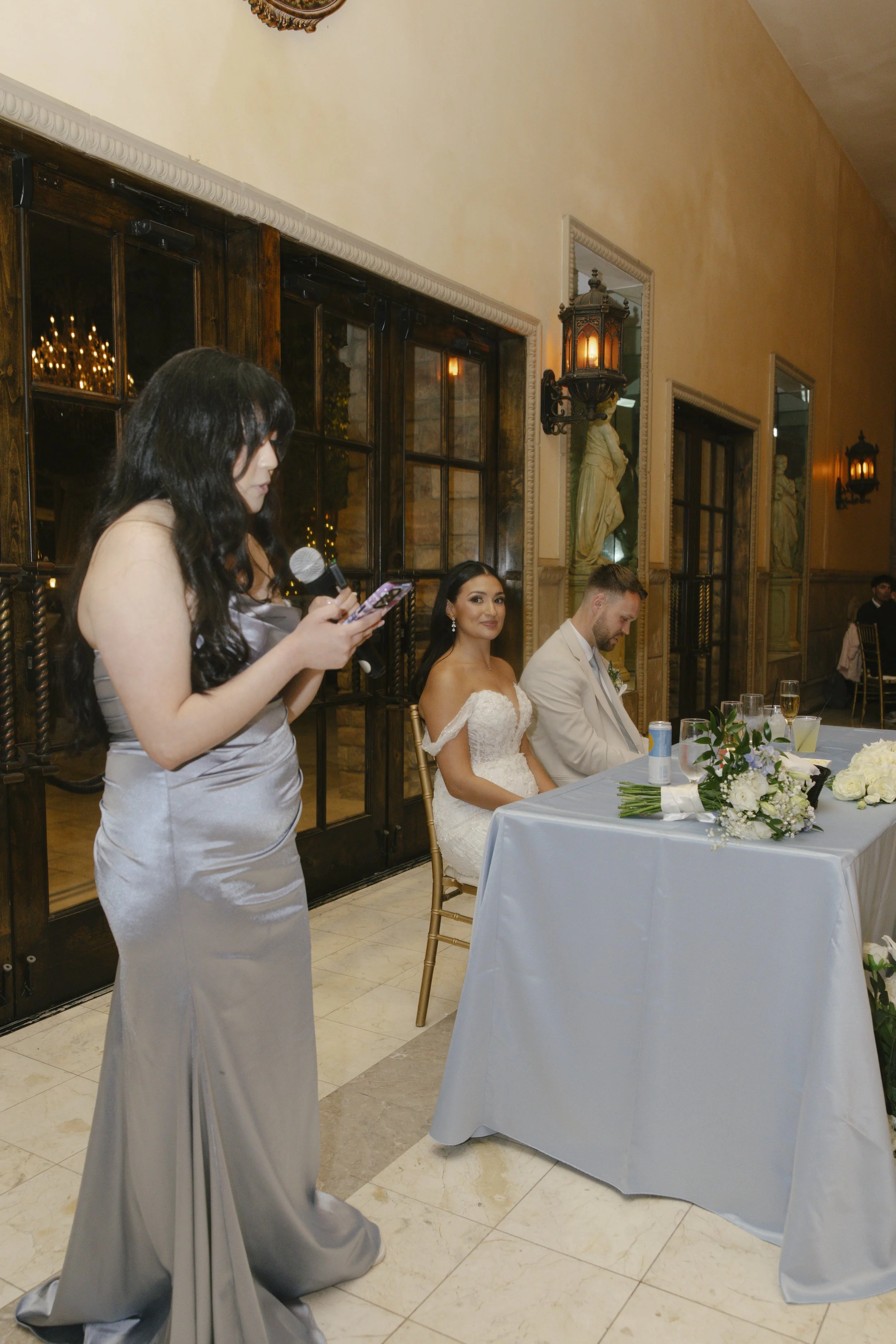 The reception celebration at Ashley Castle in Chandler, Arizona, came to life through hybrid film and digital photography, capturing elegant reception details, joyful bridal party entrances, and lively dance floor moments inside the castle’s grand ba