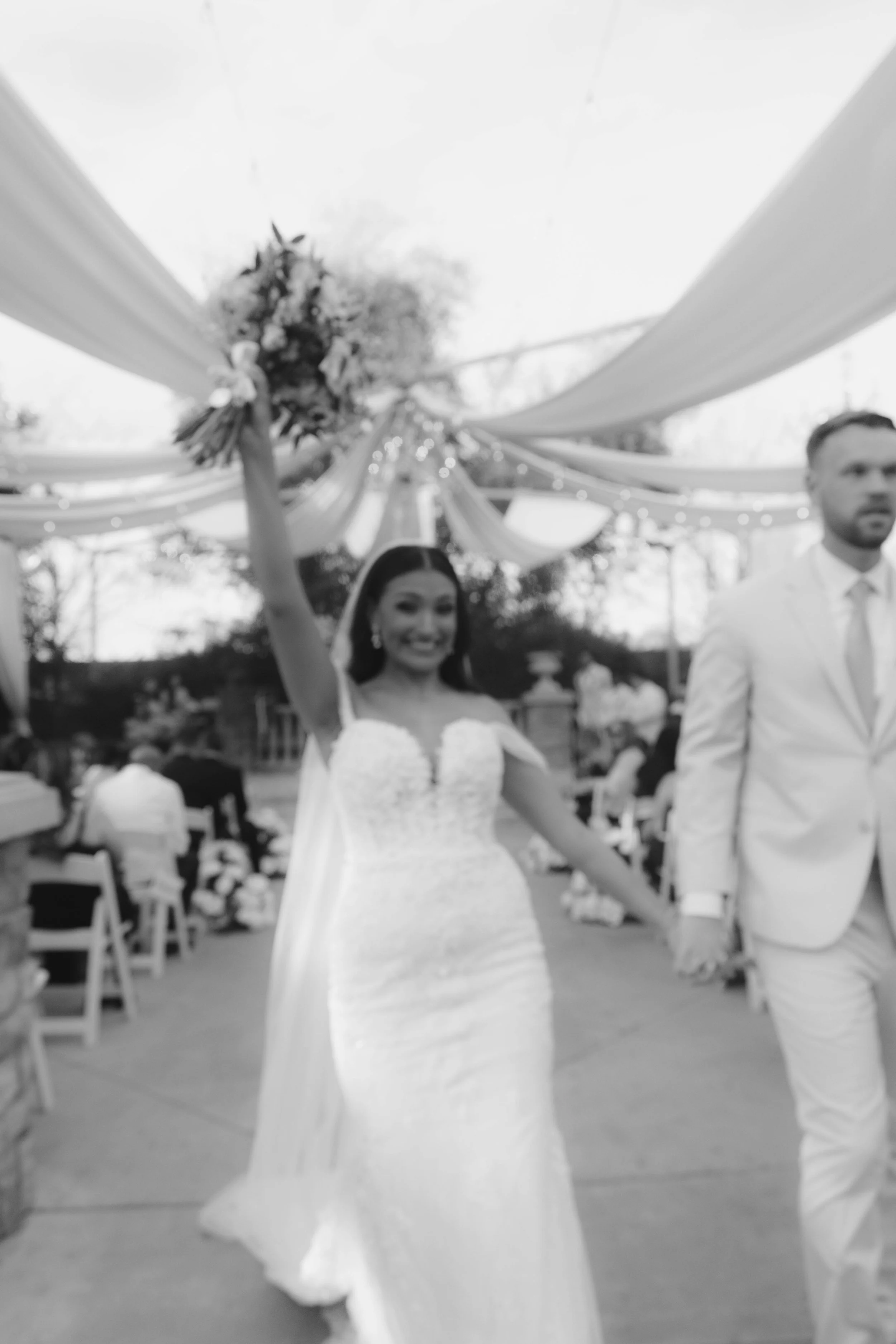 The bride and groom’s ceremony at Ashley Castle in Chandler, Arizona, was beautifully documented through hybrid film and digital photography, capturing their vows, ring exchange, and heartfelt moments beneath a romantic floral altar in the castle’s e