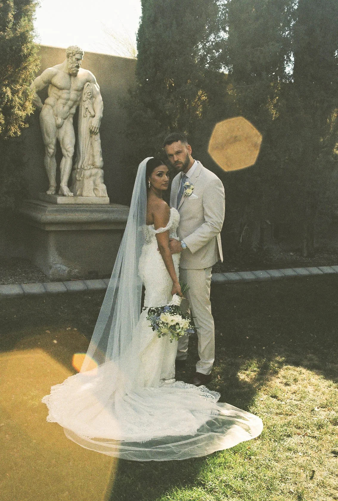 Romantic bride and groom portraits at Ashley Castle in Chandler, Arizona, captured through hybrid film and digital photography, showcase intimate newlywed moments filled with emotion, elegant garden backdrops, and timeless wedding-day connection.