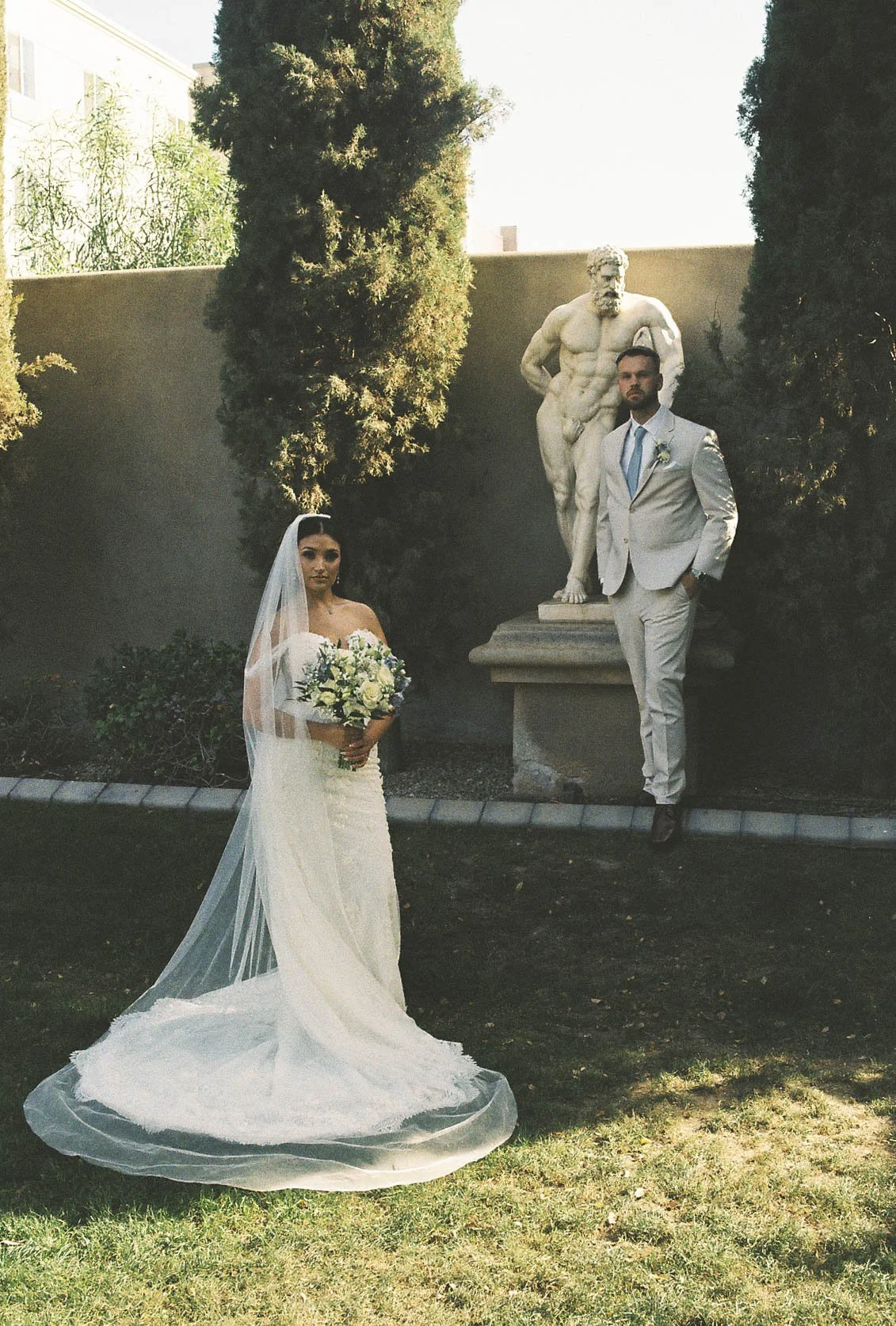 Romantic bride and groom portraits at Ashley Castle in Chandler, Arizona, captured through hybrid film and digital photography, showcase intimate newlywed moments filled with emotion, elegant garden backdrops, and timeless wedding-day connection.