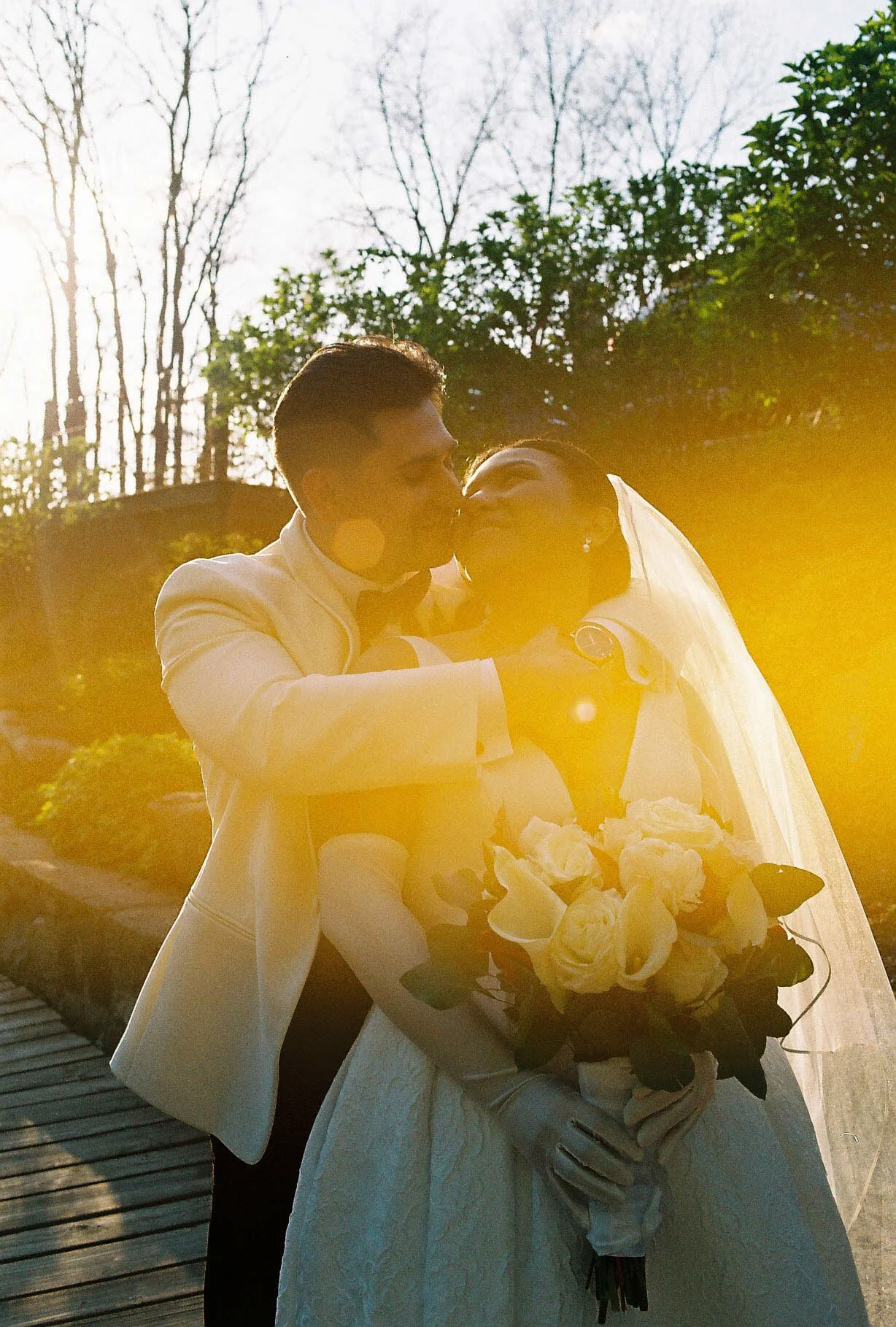 Bride and groom portraits at Hotel DuVillage showcase the venue's picturesque gardens, waterfront views, and timeless charm. Photographed on both digital and 35mm film, these wedding portraits focus on authentic connection, natural movement, and cand