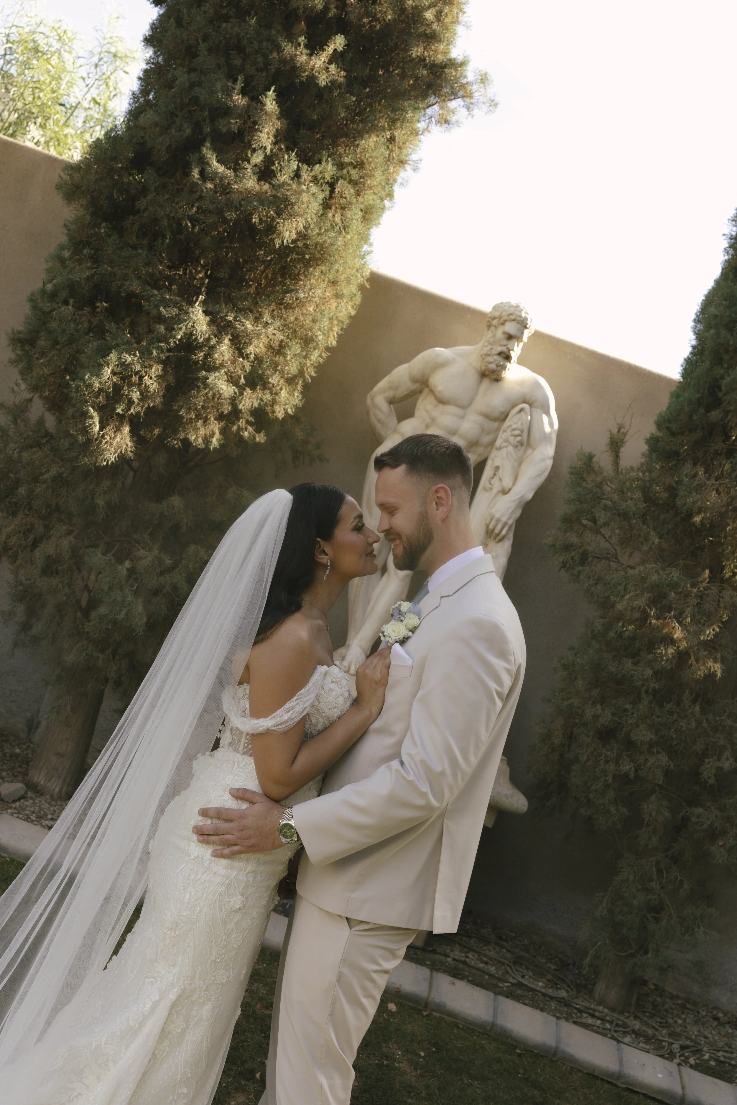 Romantic bride and groom portraits at Ashley Castle in Chandler, Arizona, captured through hybrid film and digital photography, showcase intimate newlywed moments filled with emotion, elegant garden backdrops, and timeless wedding-day connection.