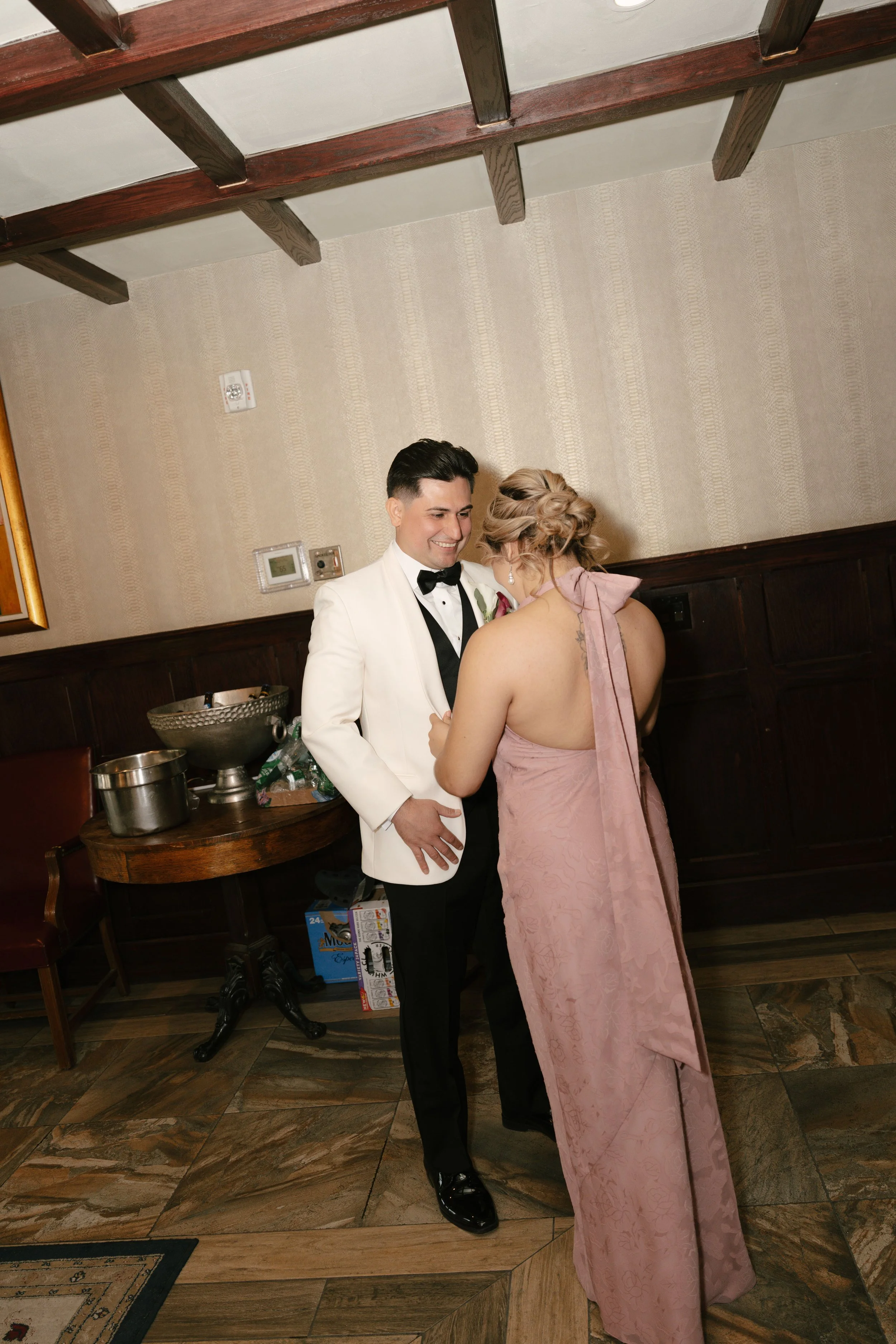 Groom getting ready at Hotel DuVillage before Andy & Elmer's May 2026 wedding. Captured by Raw By Laura using a blend of digital and 35mm film photography, documenting genuine moments with family and friends.