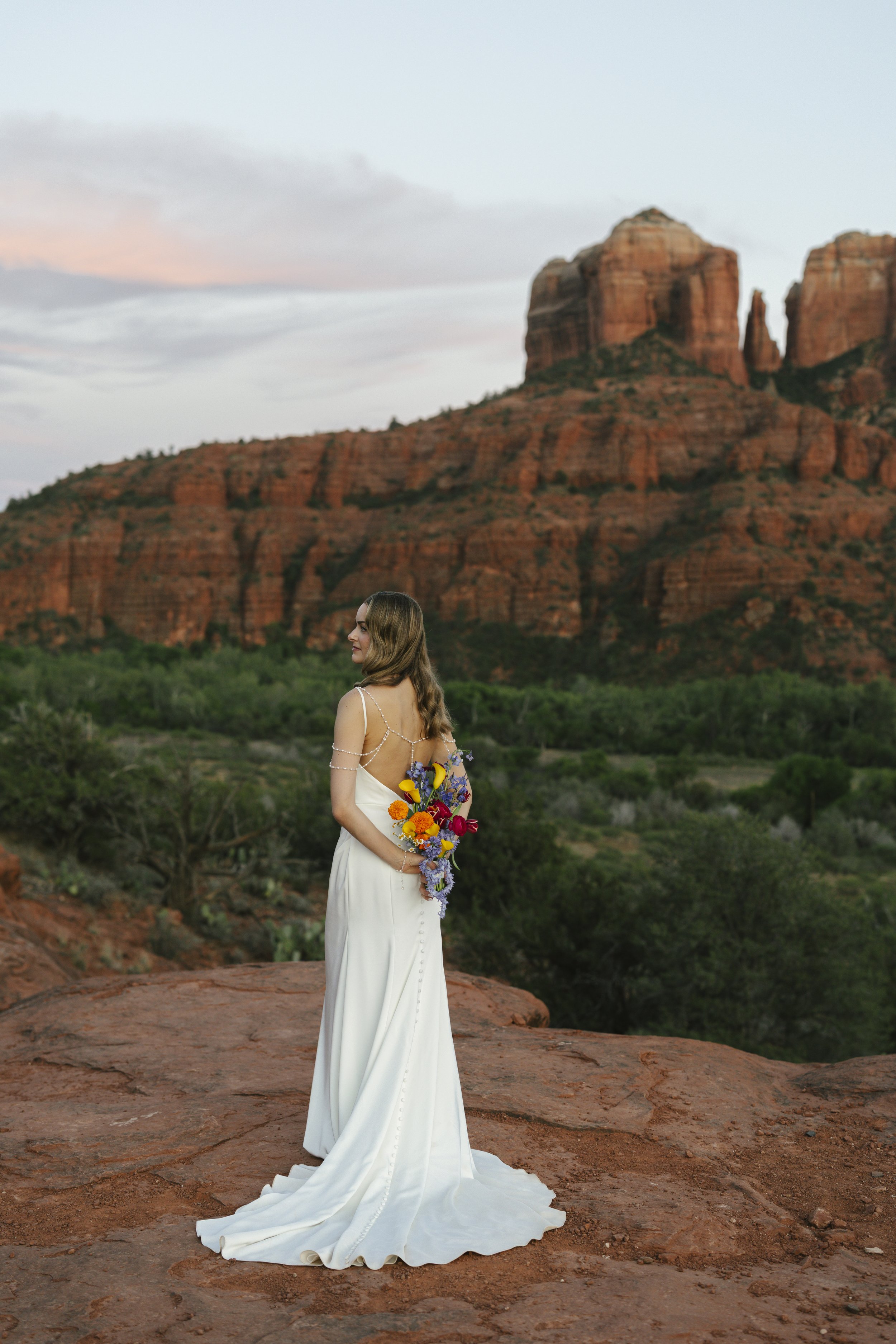 Romantic golden hour portraits at Secret Slick Rock during Chelsea and Travis' intimate Sedona elopement. Featuring Sedona's famous red rock views, stunning Arizona desert landscapes, and timeless wedding photography, these newlywed portraits perfect
