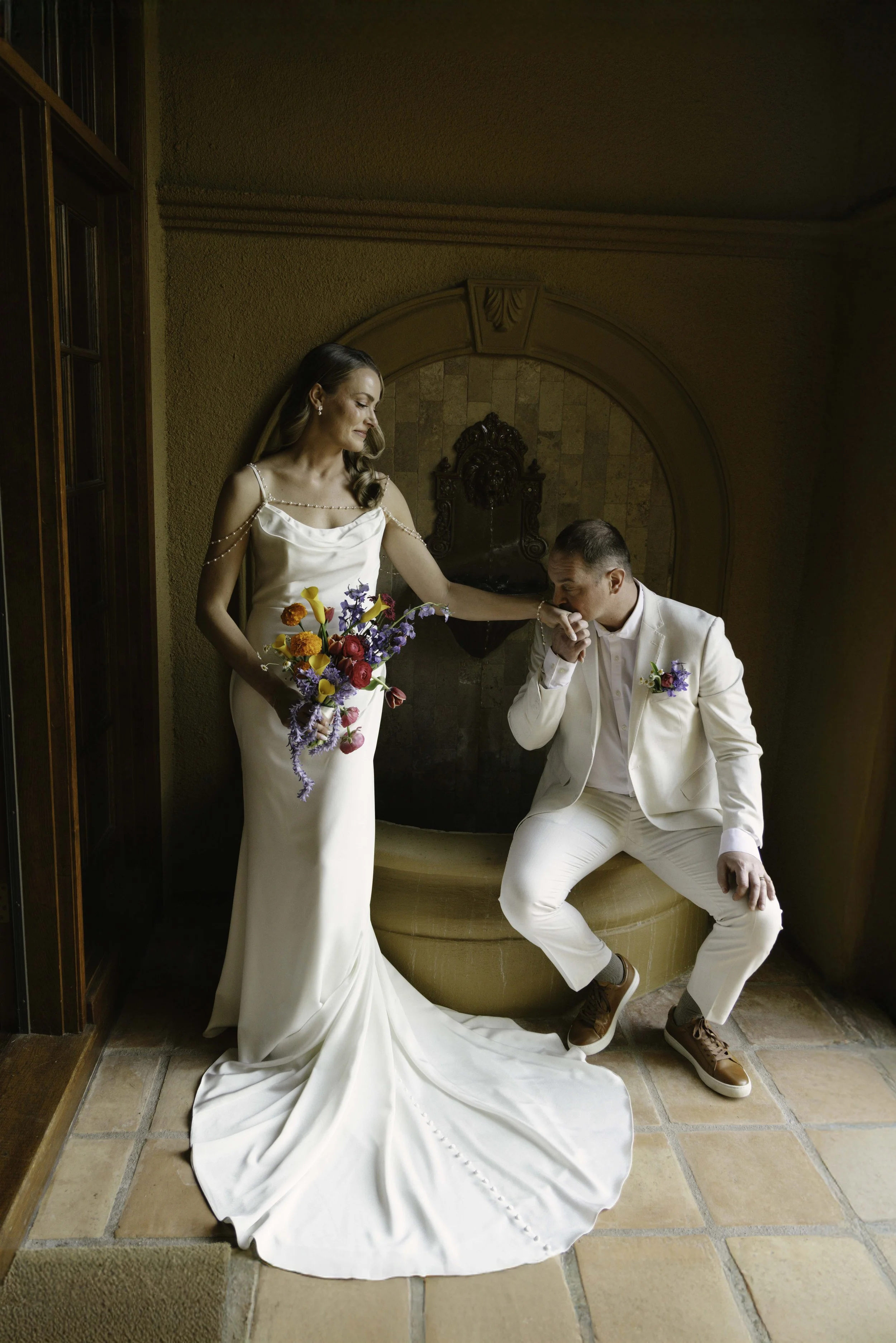 Romantic newlywed portraits from Chelsea and Travis' intimate Sedona, Arizona elopement, featuring elegant courtyard portraits, candid moments with their beloved dog, and timeless wedding photography captured after their private ceremony before golde
