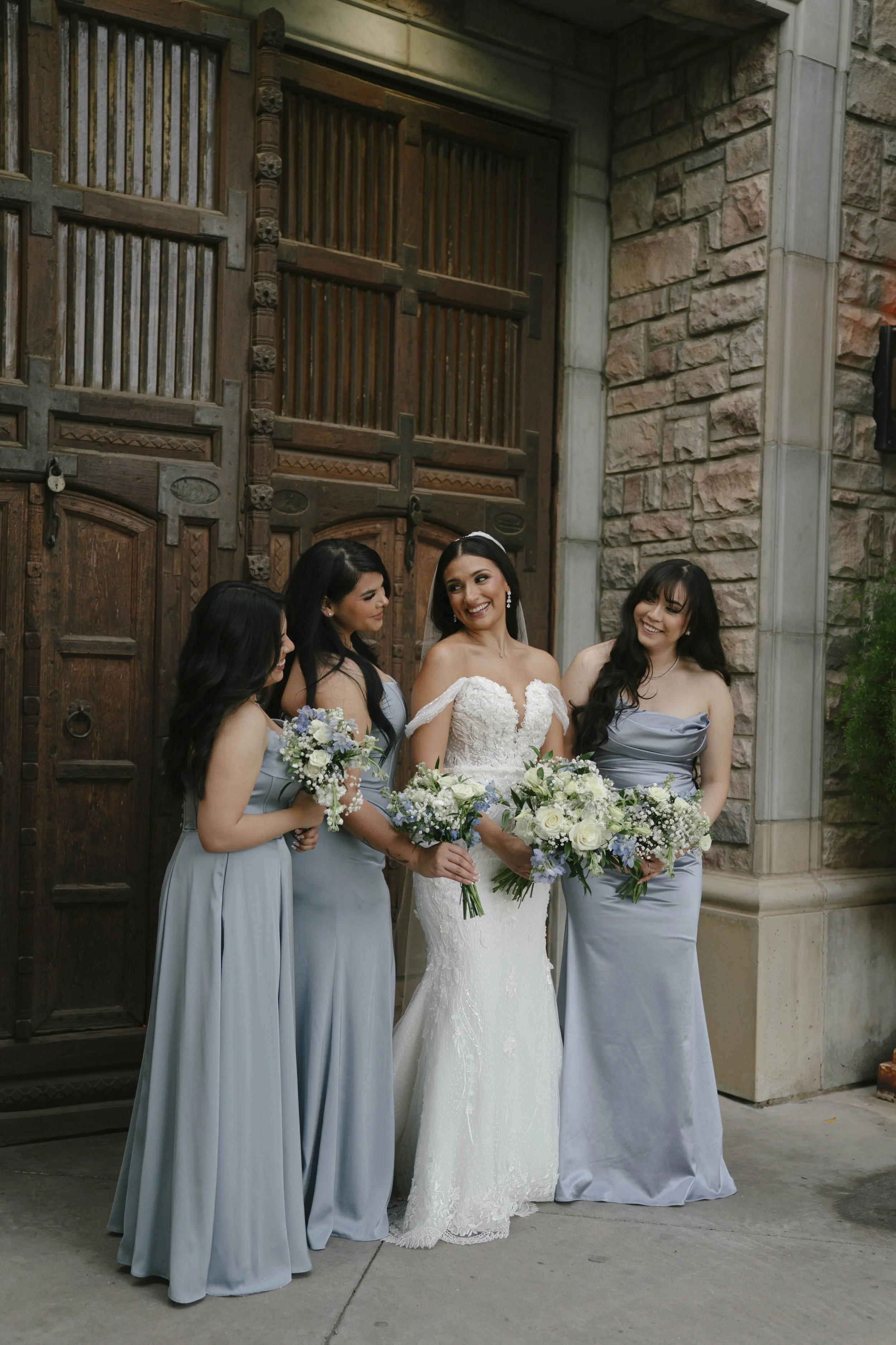 Bridal portraits at Ashley Castle in Chandler, Arizona, were captured through hybrid film and digital photography, showcasing the bride’s timeless elegance alongside her bridesmaids in the castle’s romantic courtyard gardens with soft evening light a