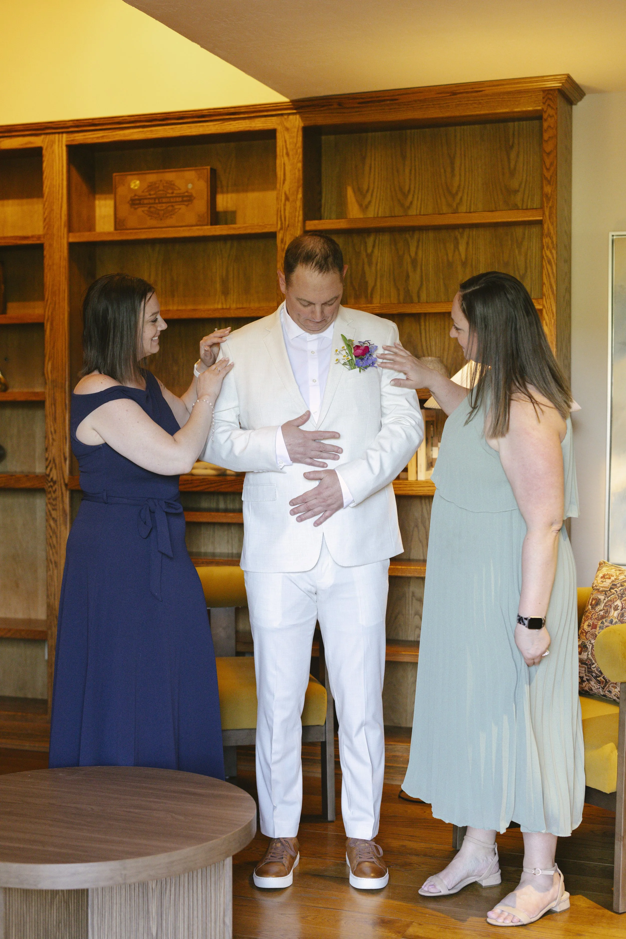Chelsea and Travis' intimate Sedona elopement began with the groom getting ready alongside his family at a private Arizona home. From tailored wedding attire and meaningful family portraits to heartfelt moments helping him prepare, every detail refle