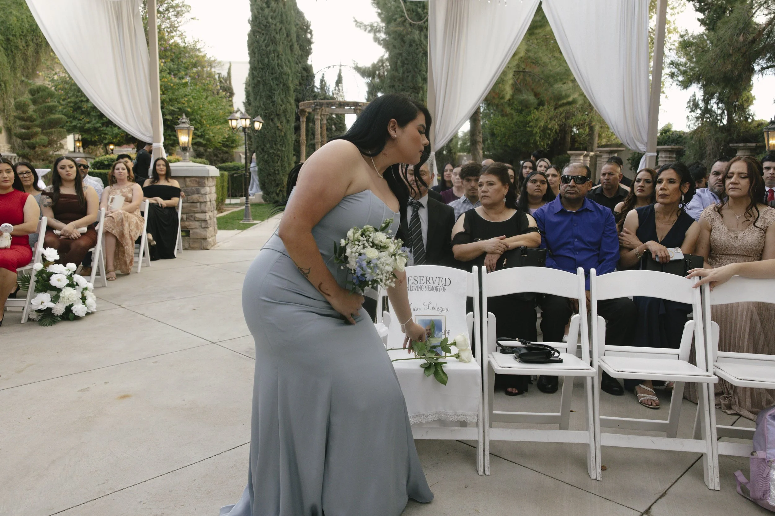 The wedding processional at Ashley Castle in Chandler, Arizona, was captured through hybrid film and digital photography, preserving the graceful entrances of the bridal party as they made their way through the romantic outdoor ceremony space surroun