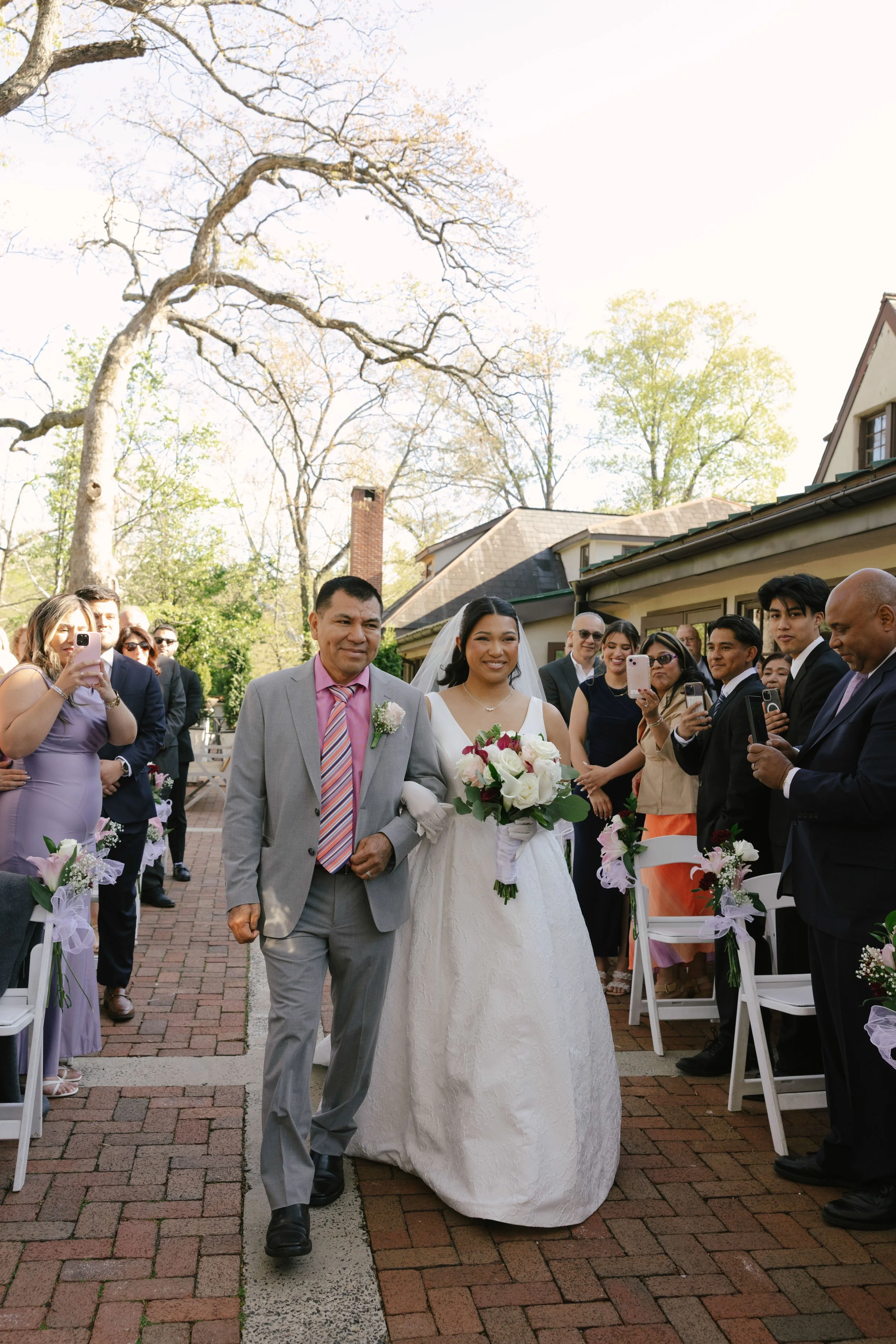 Outdoor wedding ceremony at Hotel DuVillage featuring the bride and groom, wedding party, and meaningful moments captured on both digital and 35mm film. A timeless celebration documented with a candid, documentary approach
