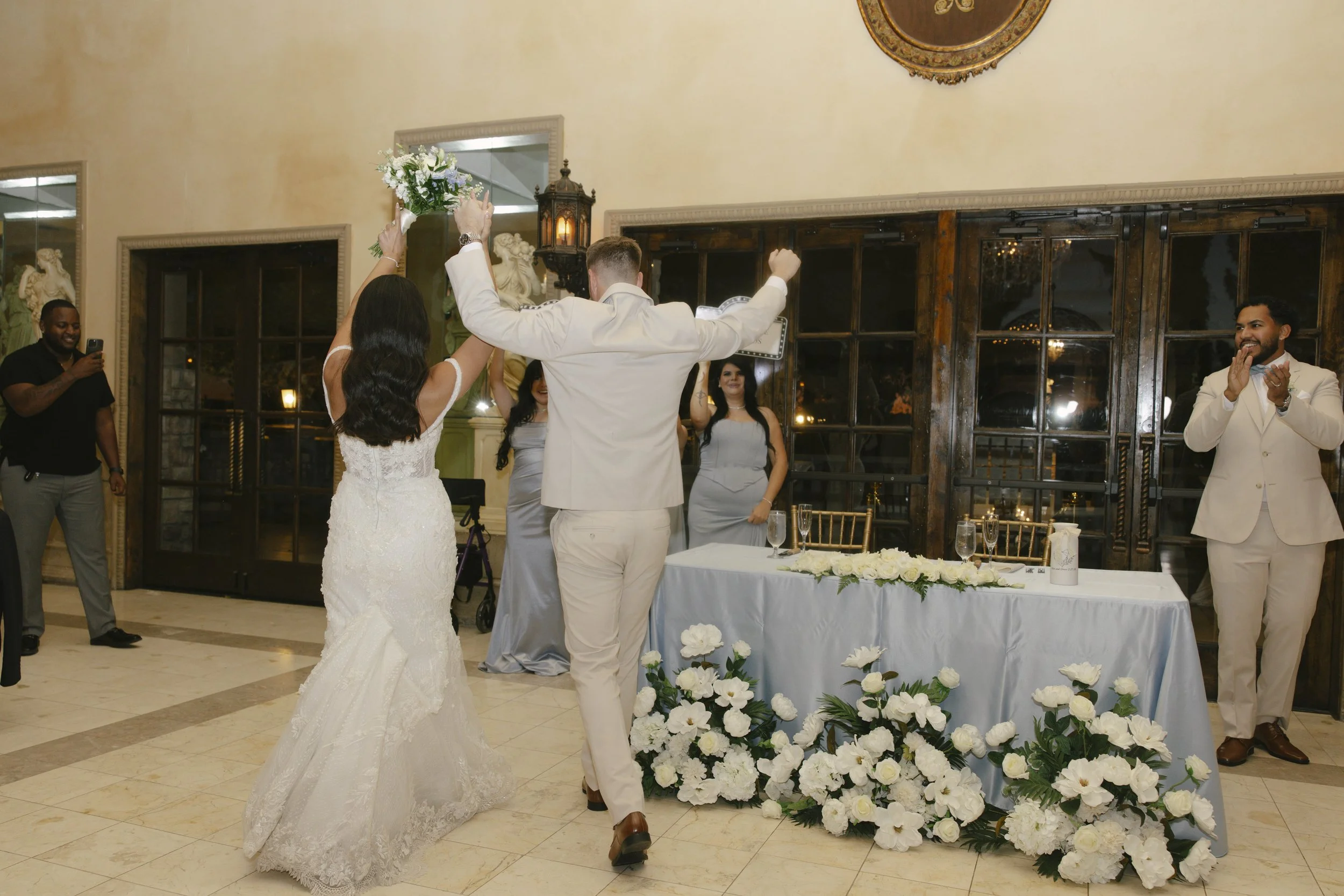 The reception celebration at Ashley Castle in Chandler, Arizona, came to life through hybrid film and digital photography, capturing elegant reception details, joyful bridal party entrances, and lively dance floor moments inside the castle’s grand ba