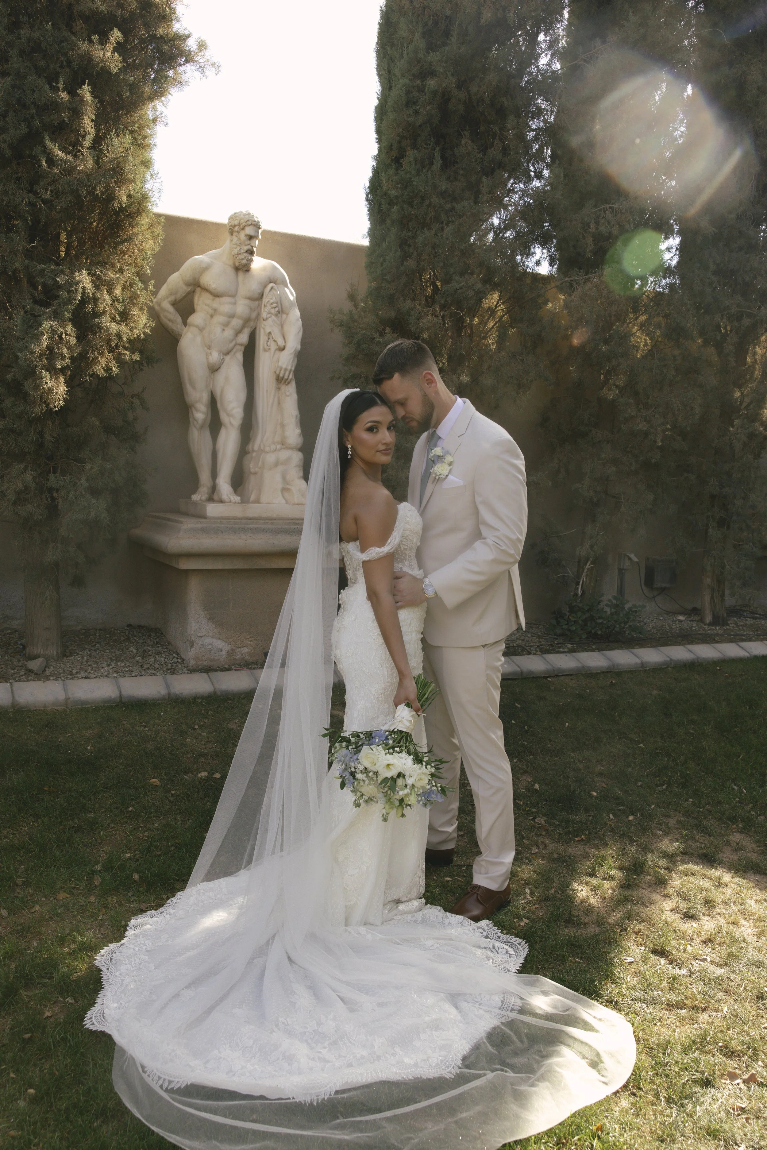 Romantic bride and groom portraits at Ashley Castle in Chandler, Arizona, captured through hybrid film and digital photography, showcase intimate newlywed moments filled with emotion, elegant garden backdrops, and timeless wedding-day connection.