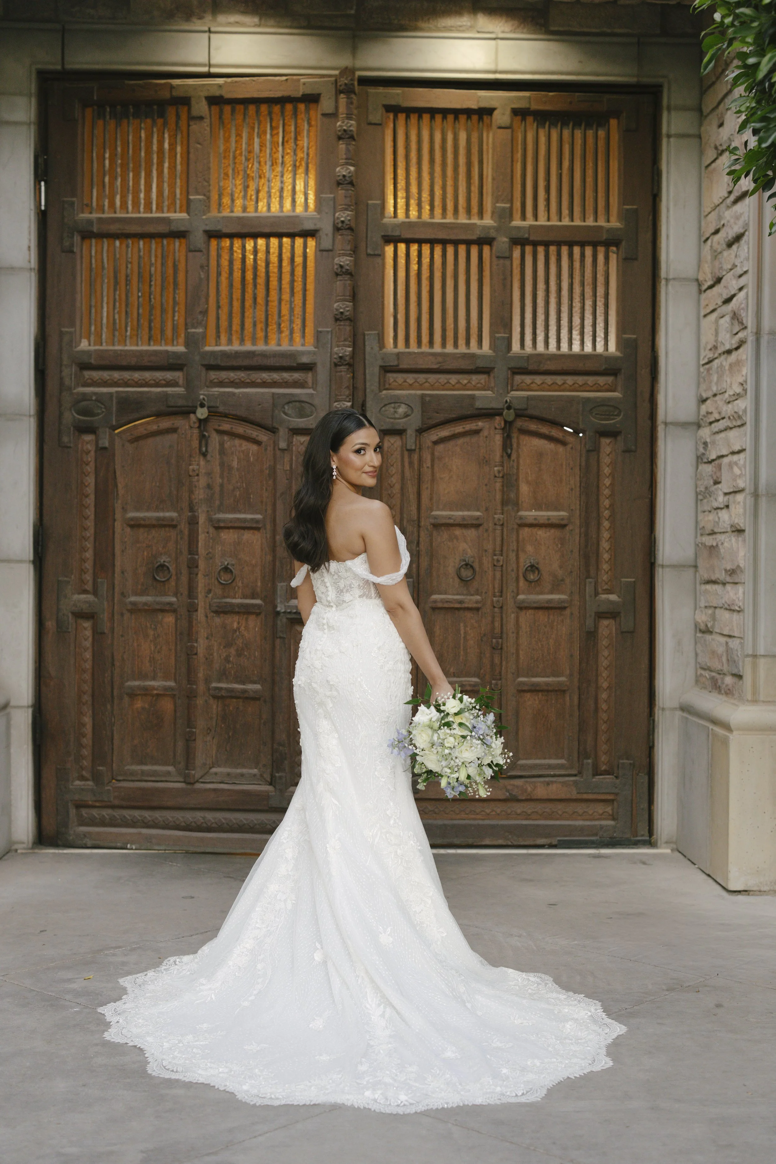 The bride’s solo portraits at Ashley Castle in Chandler, Arizona, were captured through hybrid film and digital photography, highlighting timeless bridal elegance with romantic veil details, graceful movement, and the castle’s stunning courtyard and 