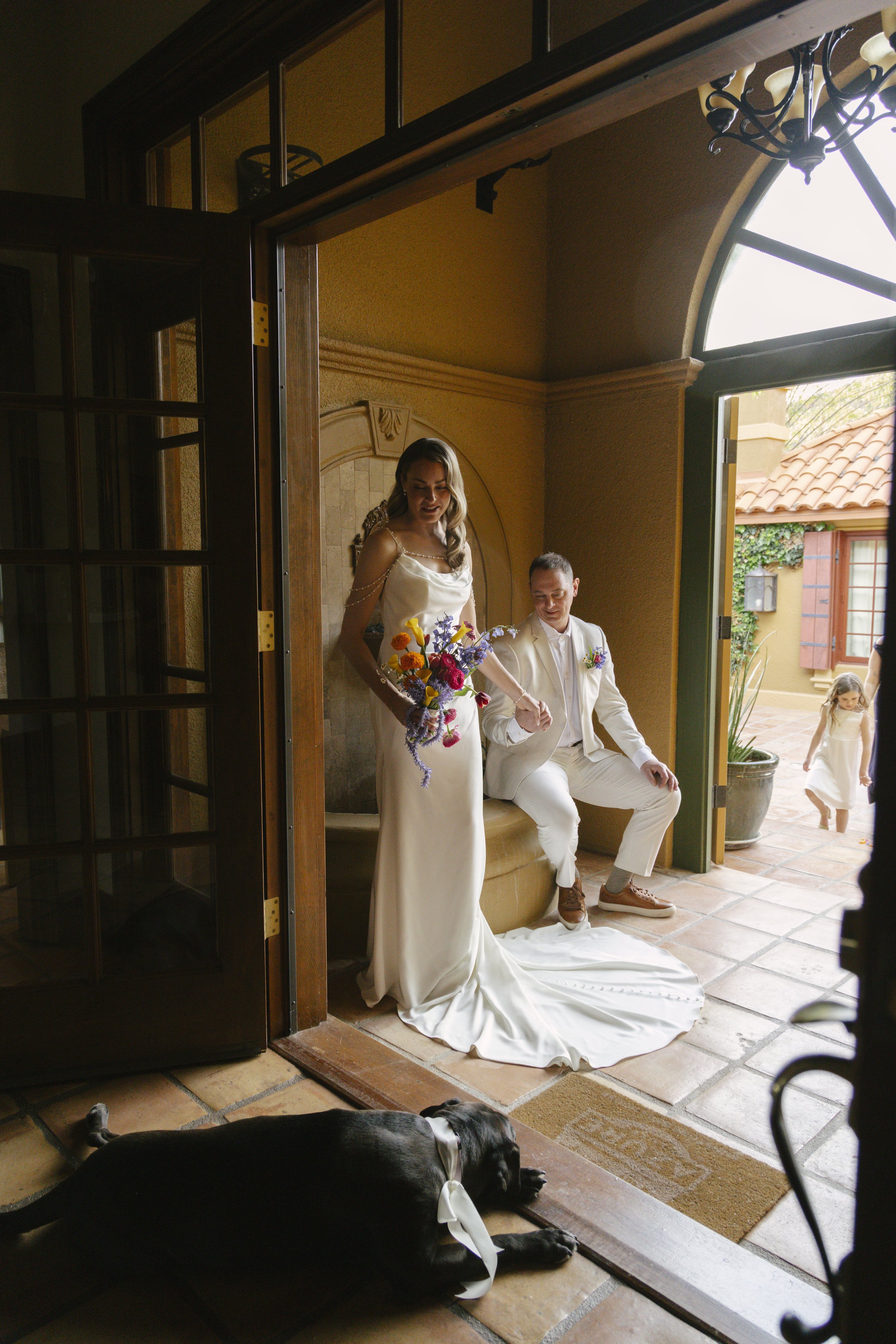 Romantic newlywed portraits from Chelsea and Travis' intimate Sedona, Arizona elopement, featuring elegant courtyard portraits, candid moments with their beloved dog, and timeless wedding photography captured after their private ceremony before golde