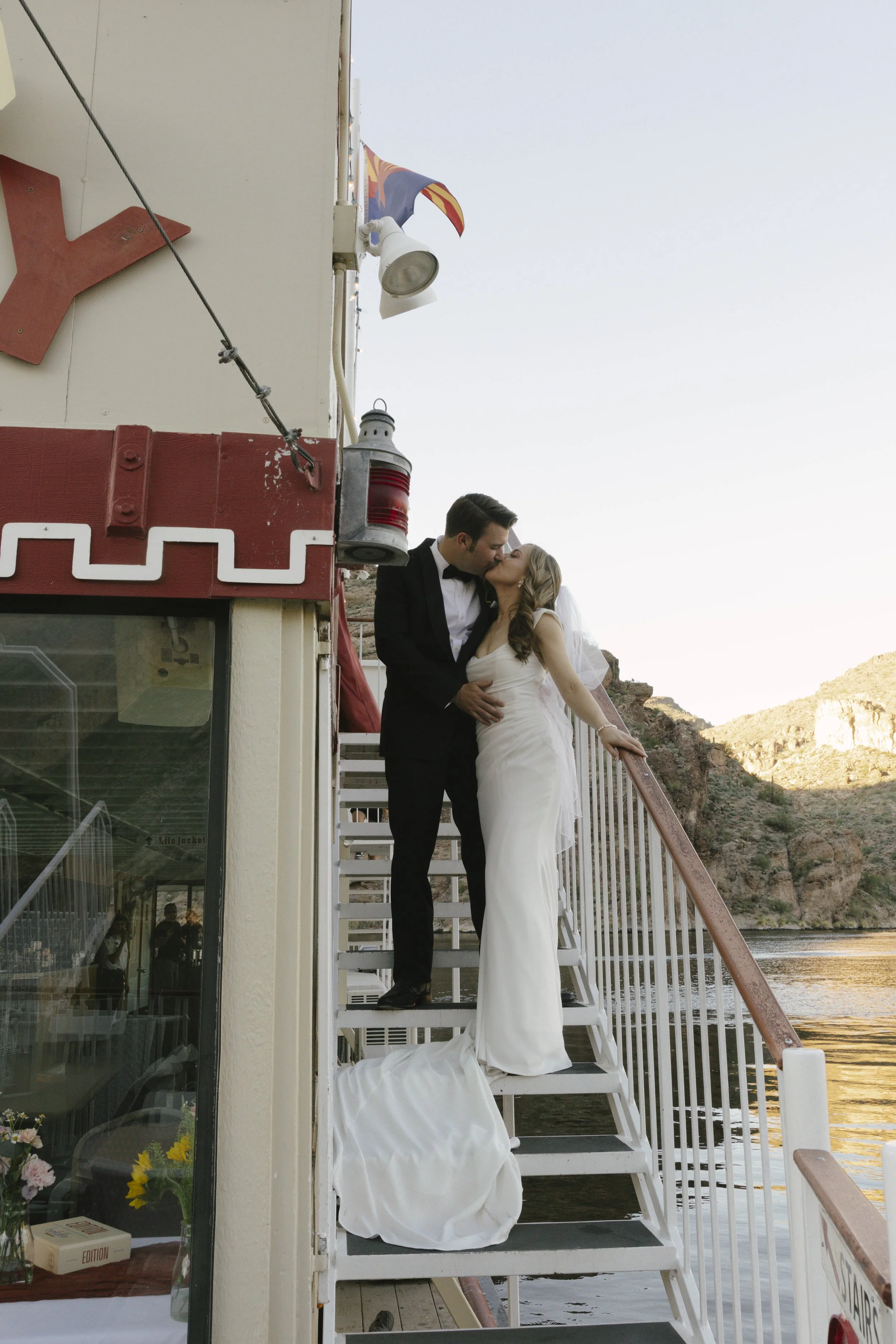With Canyon Lake’s towering desert cliffs surrounding them, the couple exchanged rings and said “I do” aboard the Dolly Steamboat. Surrounded by about 60 of their closest friends and family, the ceremony took place on the deck with breathtaking Arizo