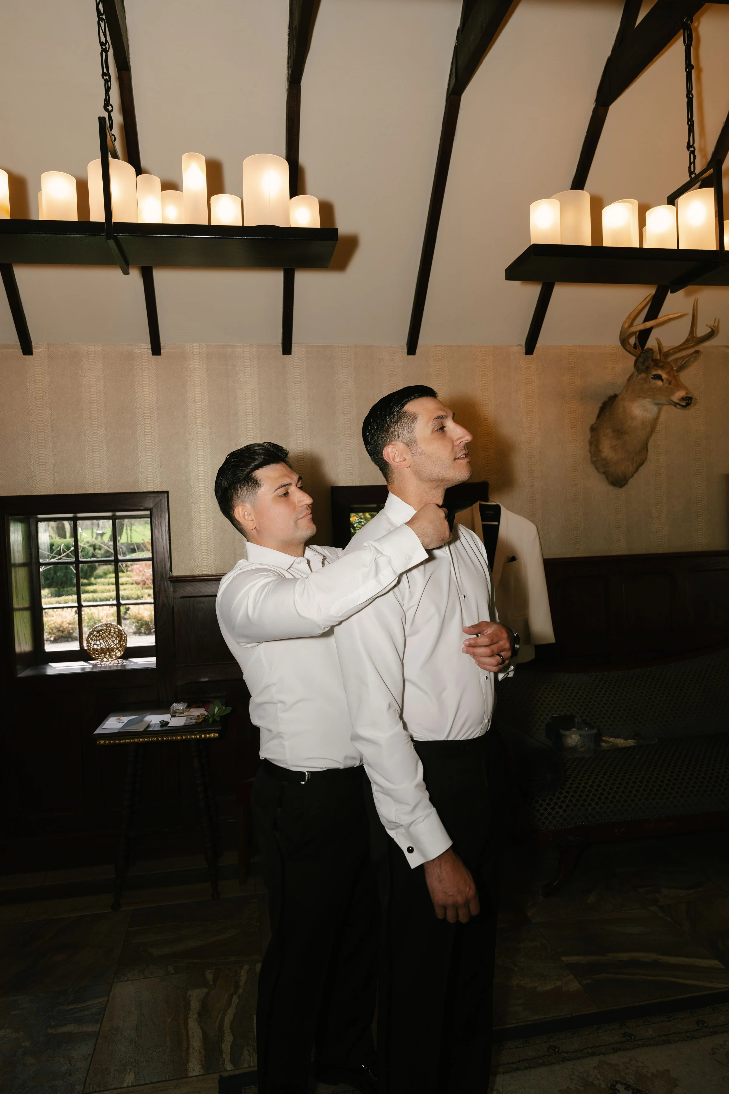 Groom getting ready at Hotel DuVillage before Andy & Elmer's May 2026 wedding. Captured by Raw By Laura using a blend of digital and 35mm film photography, documenting genuine moments with family and friends.