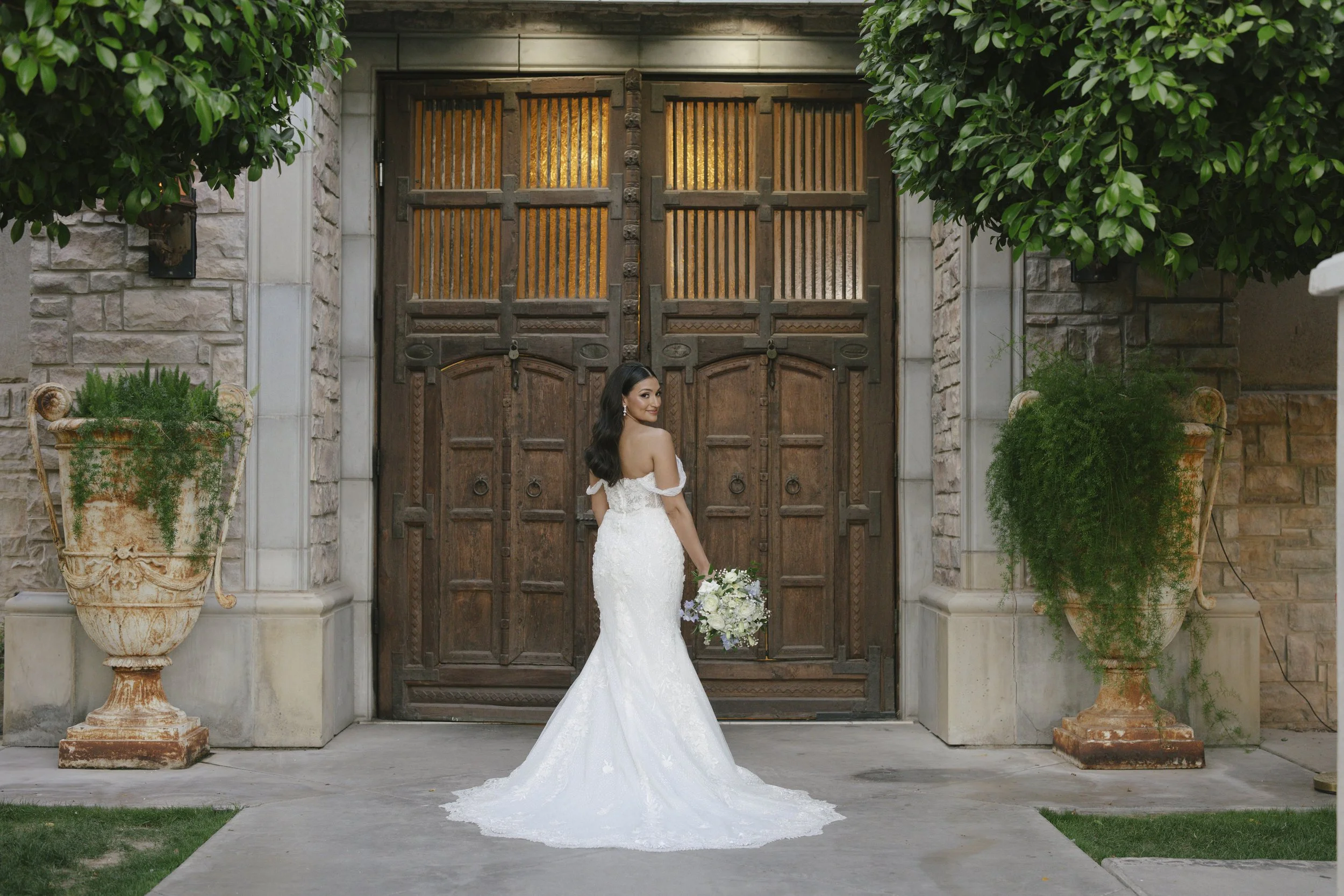 The bride’s solo portraits at Ashley Castle in Chandler, Arizona, were captured through hybrid film and digital photography, highlighting timeless bridal elegance with romantic veil details, graceful movement, and the castle’s stunning courtyard and 