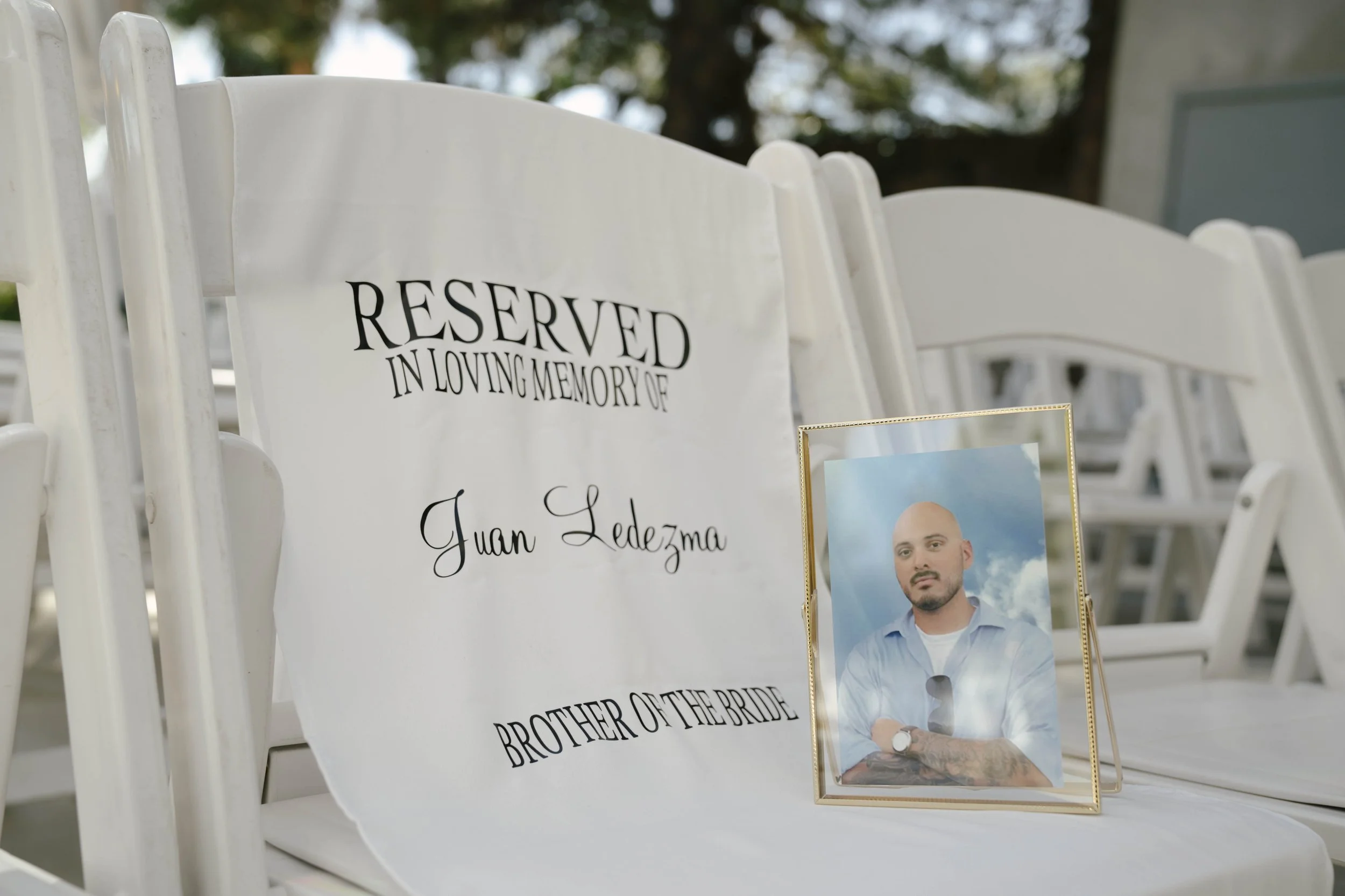 Elegant wedding details from the bride and groom’s Ashley Castle wedding in Chandler, Arizona, featuring romantic ceremony décor, personalized memorial touches, and timeless reception styling at one of Arizona’s premier luxury wedding venues.