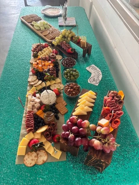 Charcuterie board with cheeses, grapes, berries, meats, and nuts