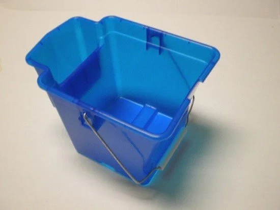 Blue plastic cleaning bucket with a metal handle on a white surface.
