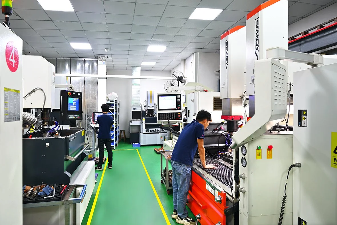 Industrial manufacturing facility with CNC machines and workers