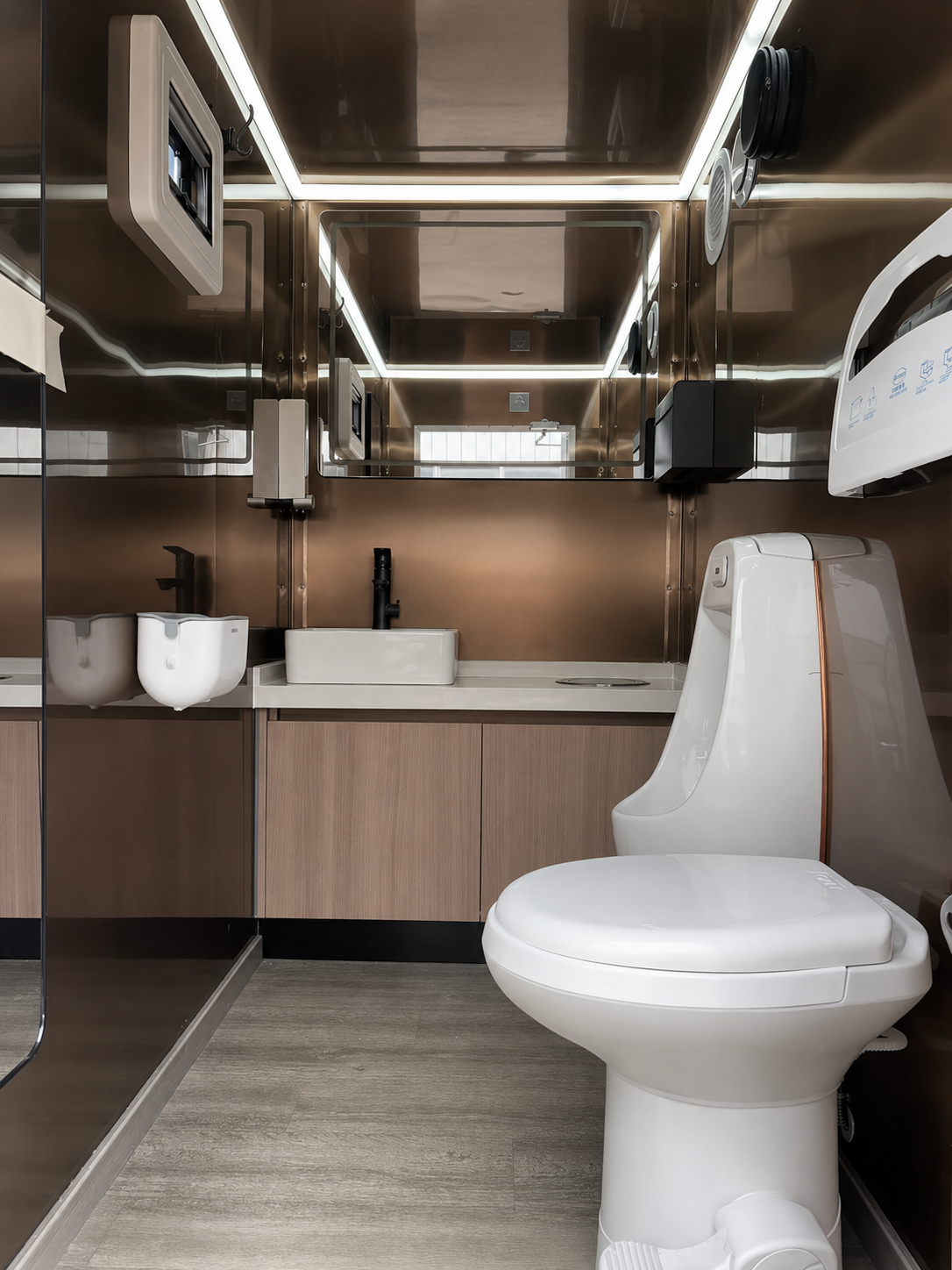 Men's modern bathroom toilet trailer in copper interior with running water, climate control, full length mirror. Designed for weddings in Rethymno, Heraklion, Chania, Elounda, and all of Crete.