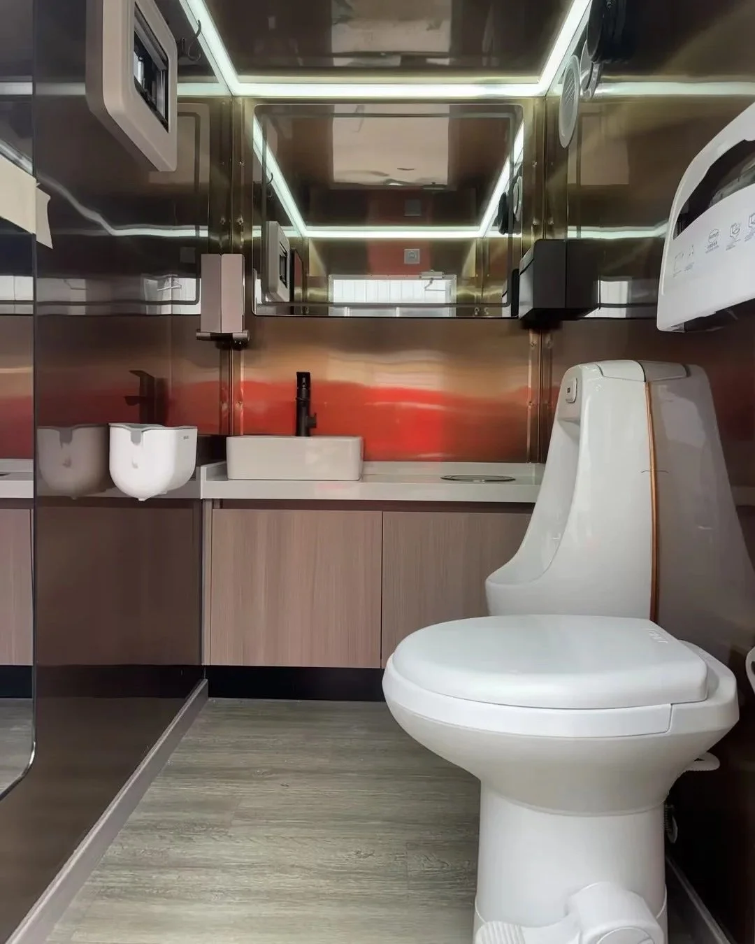 Mens modern bathroom with running water, foot flushing toilet and urinal, climate control.