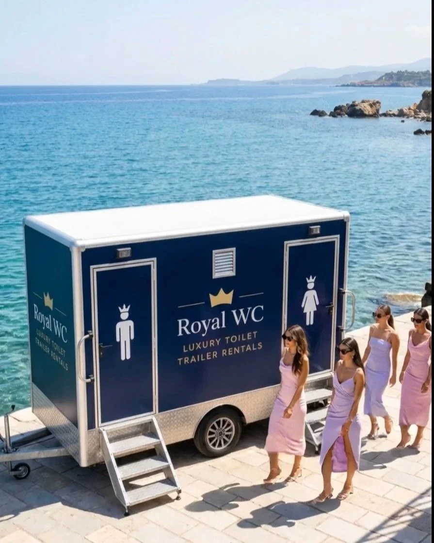 Royal WC luxury toilet trailer for weddings and private events in Crete Greece. Blue exterior restroom trailer and copper interior with air conditioning, flushing toilets, running water and full length mirrors.