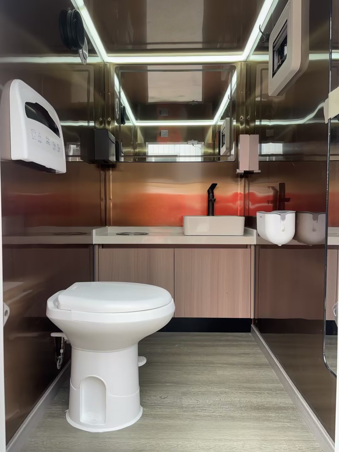 Ladies modern bathroom with running water, foot flushing toilet, climate control, full length mirror.