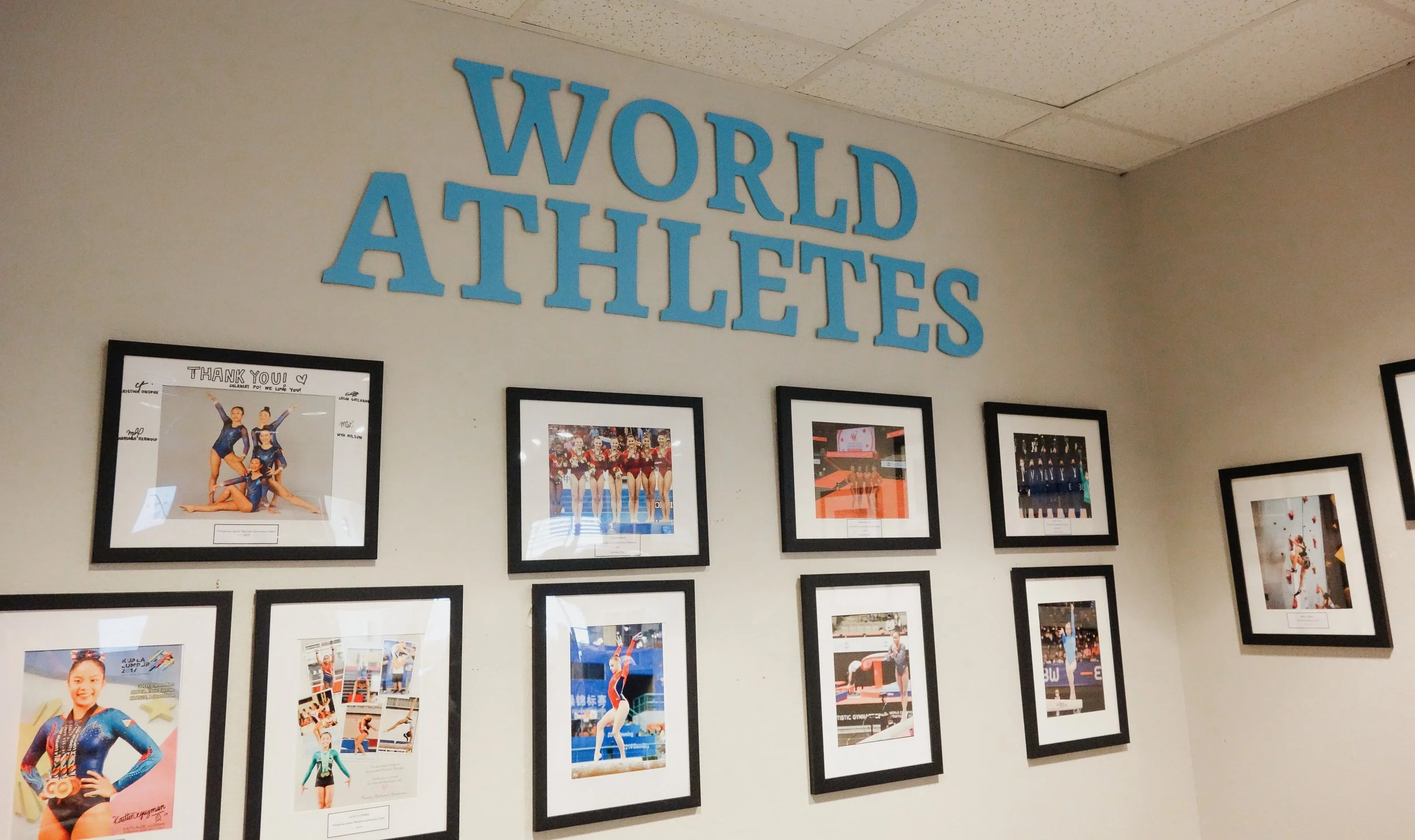 World Athletes Wall
Wall featuring framed athlete photos beneath large “World Athletes” lettering.