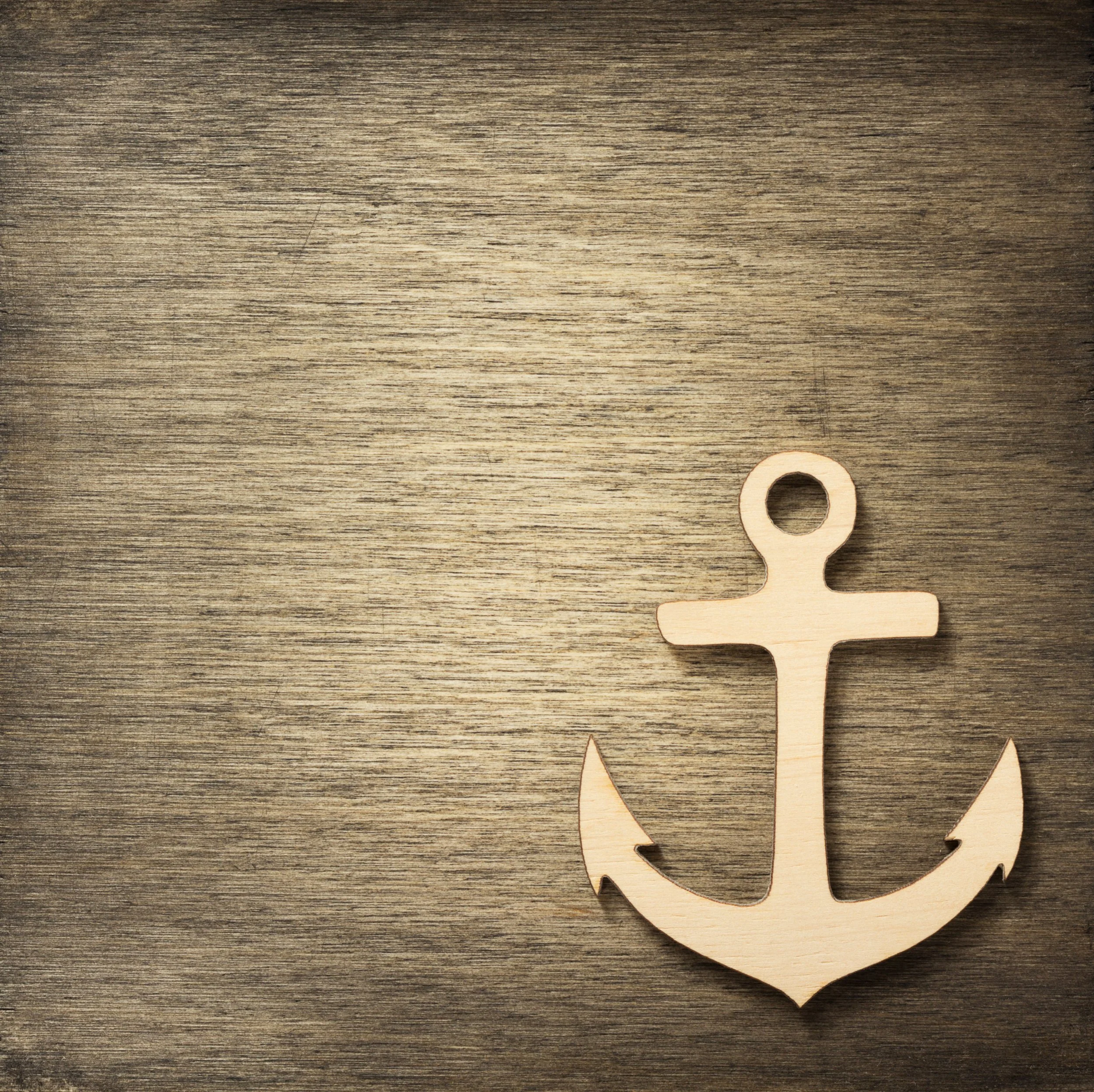 Wooden anchor placed on a wooden surface.