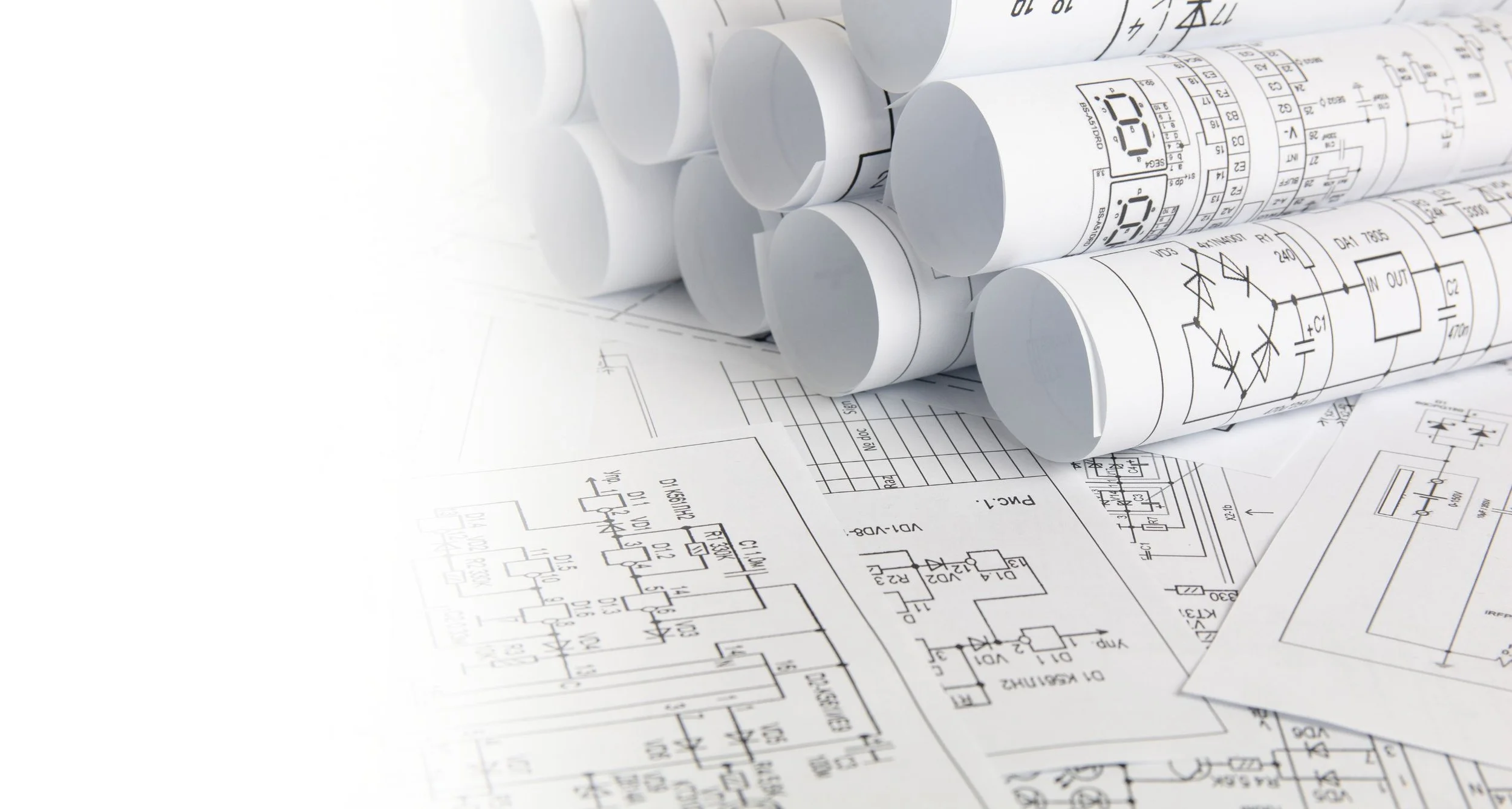 Rolling blueprints and technical drawings of electronic circuits.