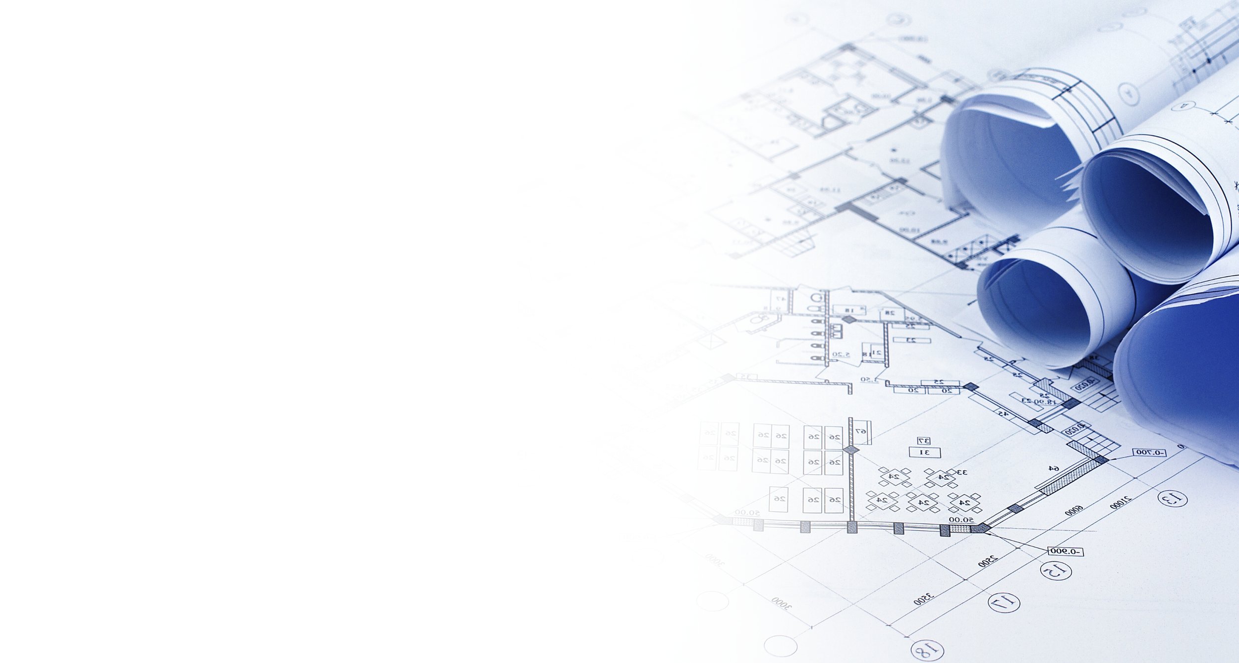 Architectural blueprints and rolled-up plans on a table.