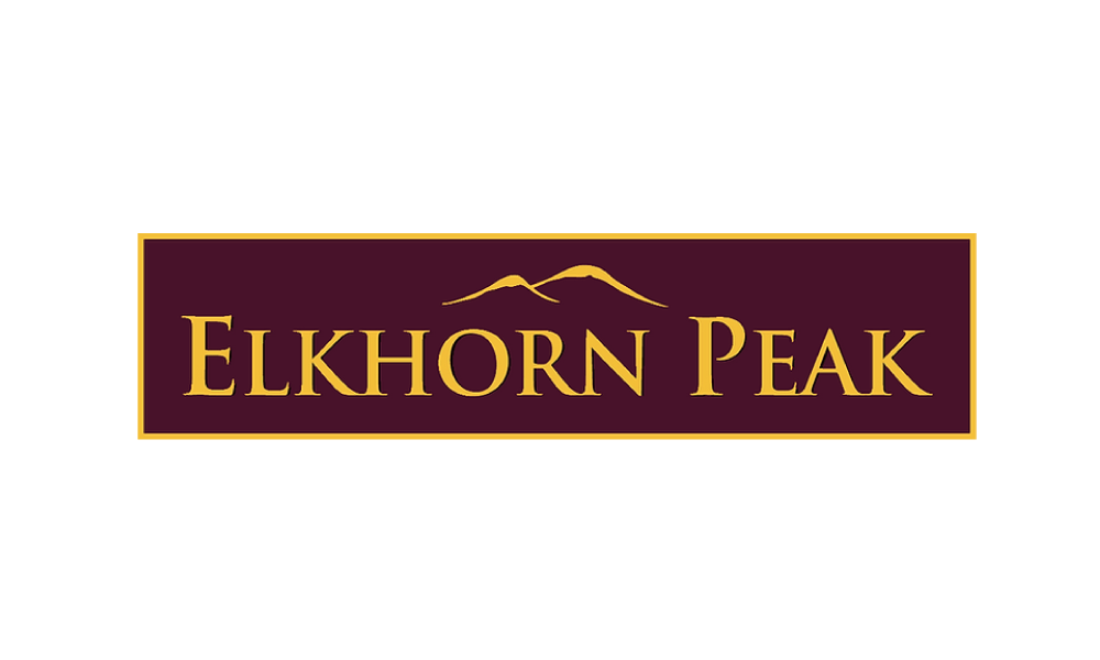 Logo for Elkhorn Peak with a mountain outline above the name, purple background, gold border, and gold text.