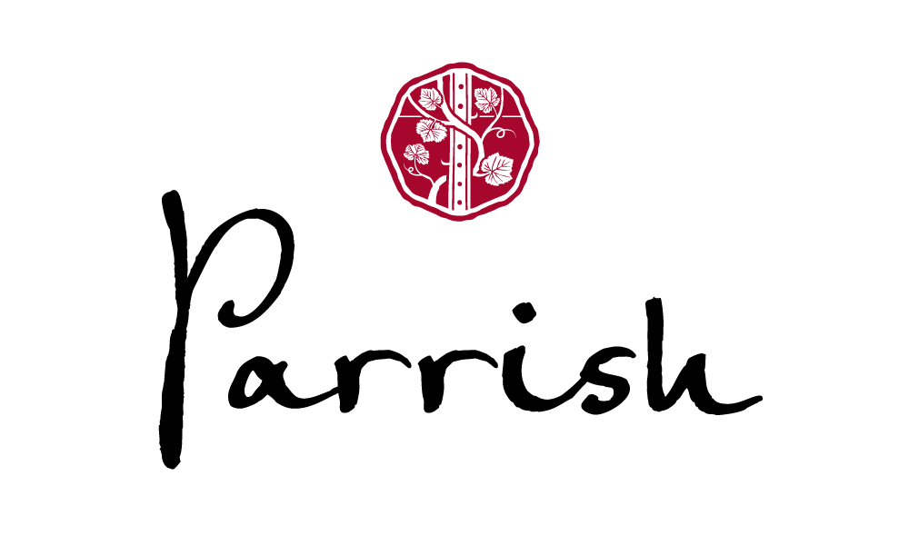 Parrish Family Vineyard - Black and white logo with a red circle containing a decorative design.