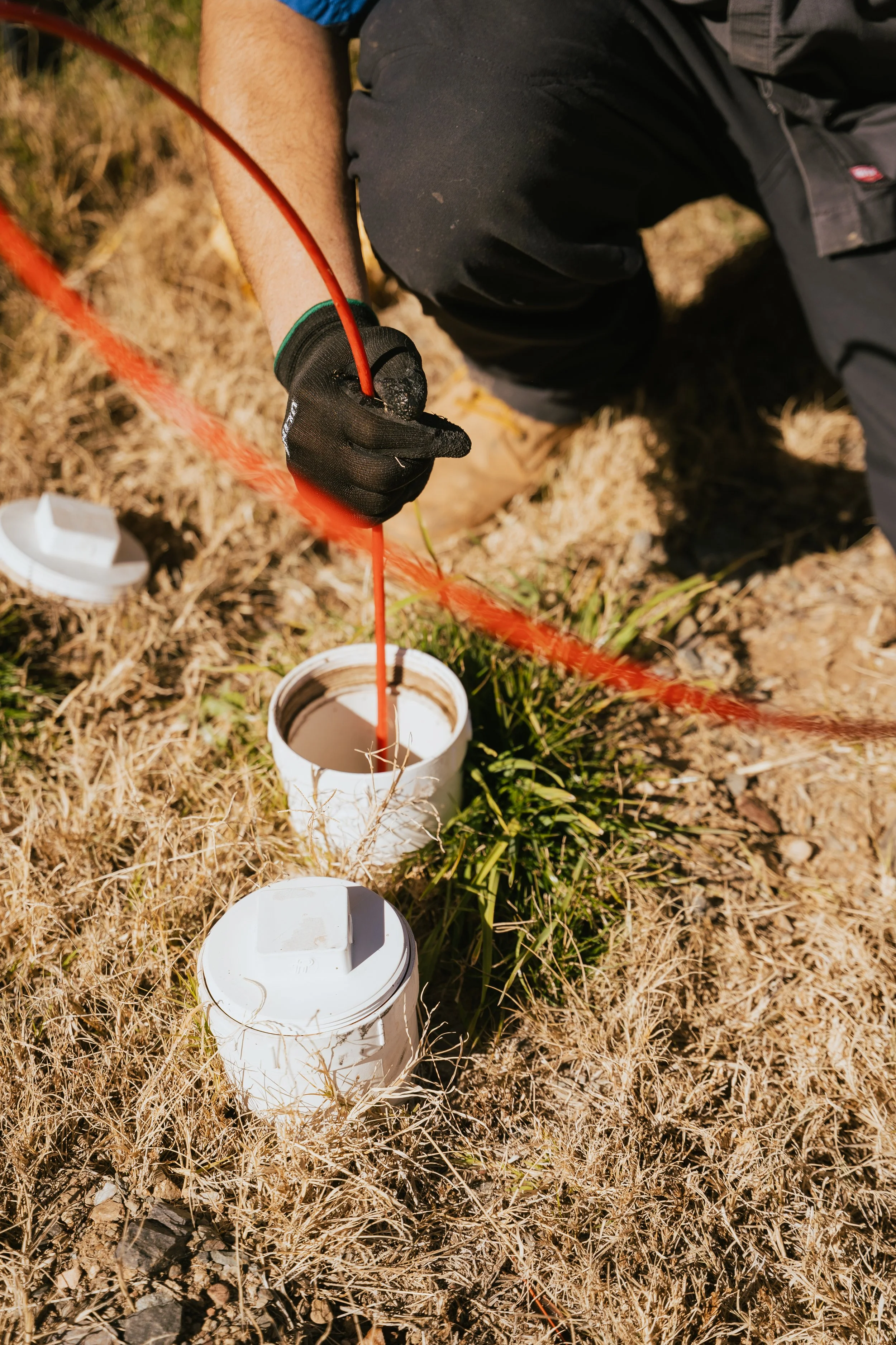 JT's Septic employee scoping a line representing their fast, calm response when something isn't right.
