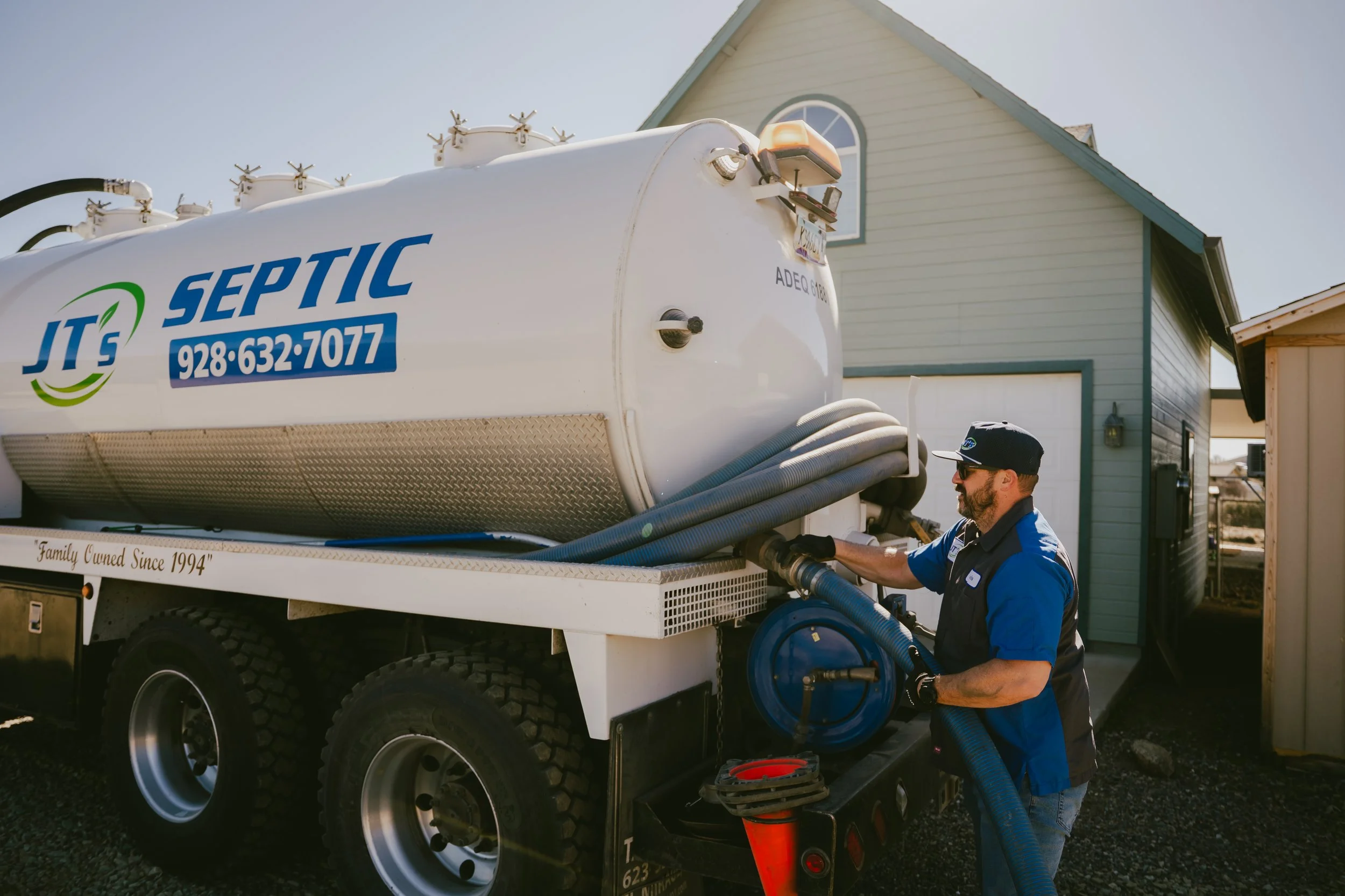 A JT's Septic employee preps a pump truck for a septic tank pumping service in Yavapai County - including Prescott, Prescott Valley, Dewey, Humboldt, and Chino Valley.