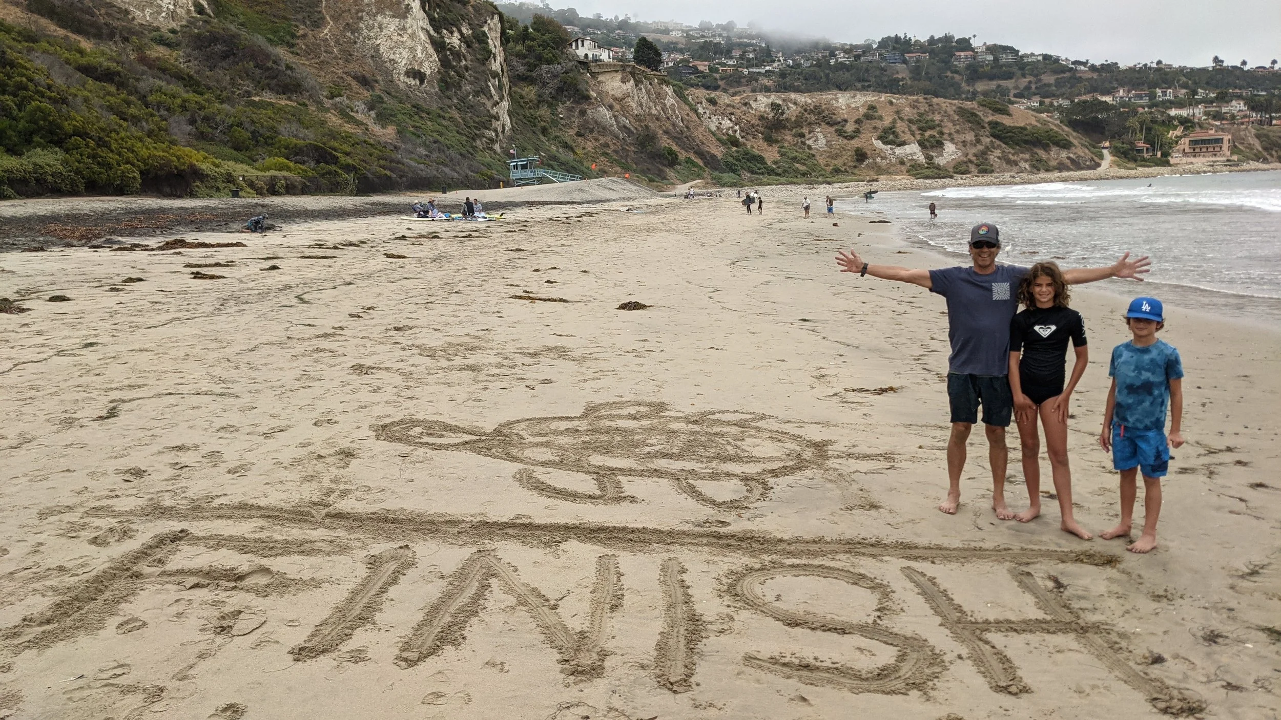 My two children and I at Rat Beach for a virtual run for the turtles. We are standing at the finish line.